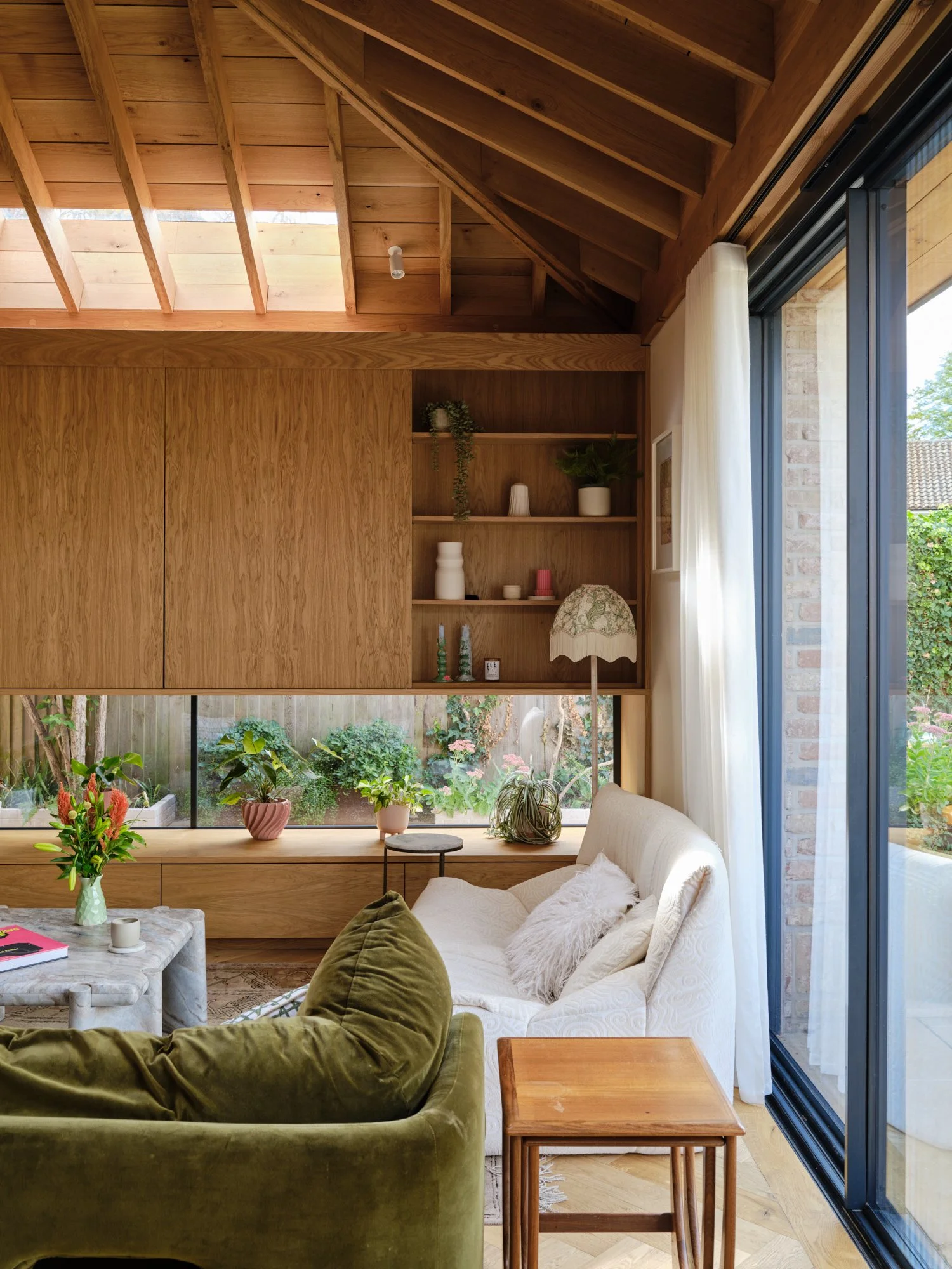 Living area with built-in oak shelving and views to the garden, Cromwell Road, Teddington