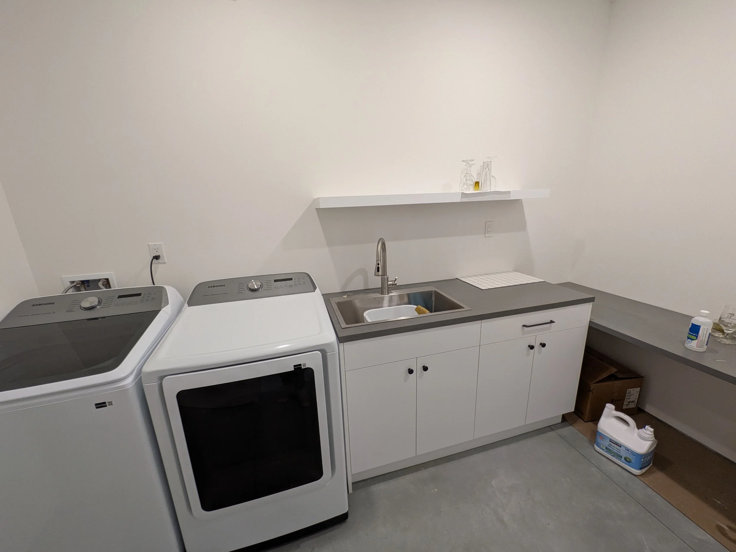 Laundry room with adjacent folding/crafting surface