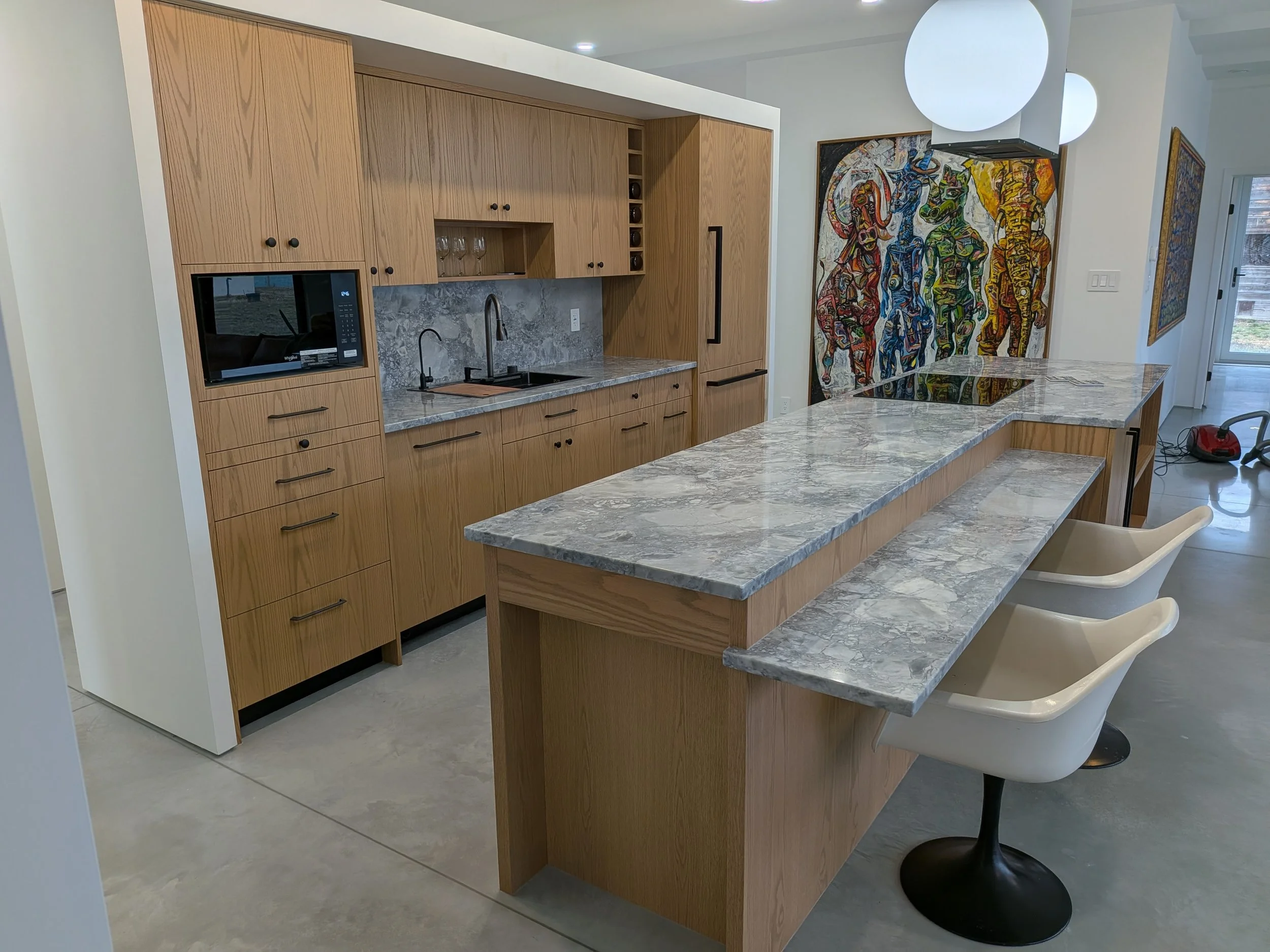 Red Oak slab doors, appliance panels, custom build and fit. Butcher block cutting board below microwave.