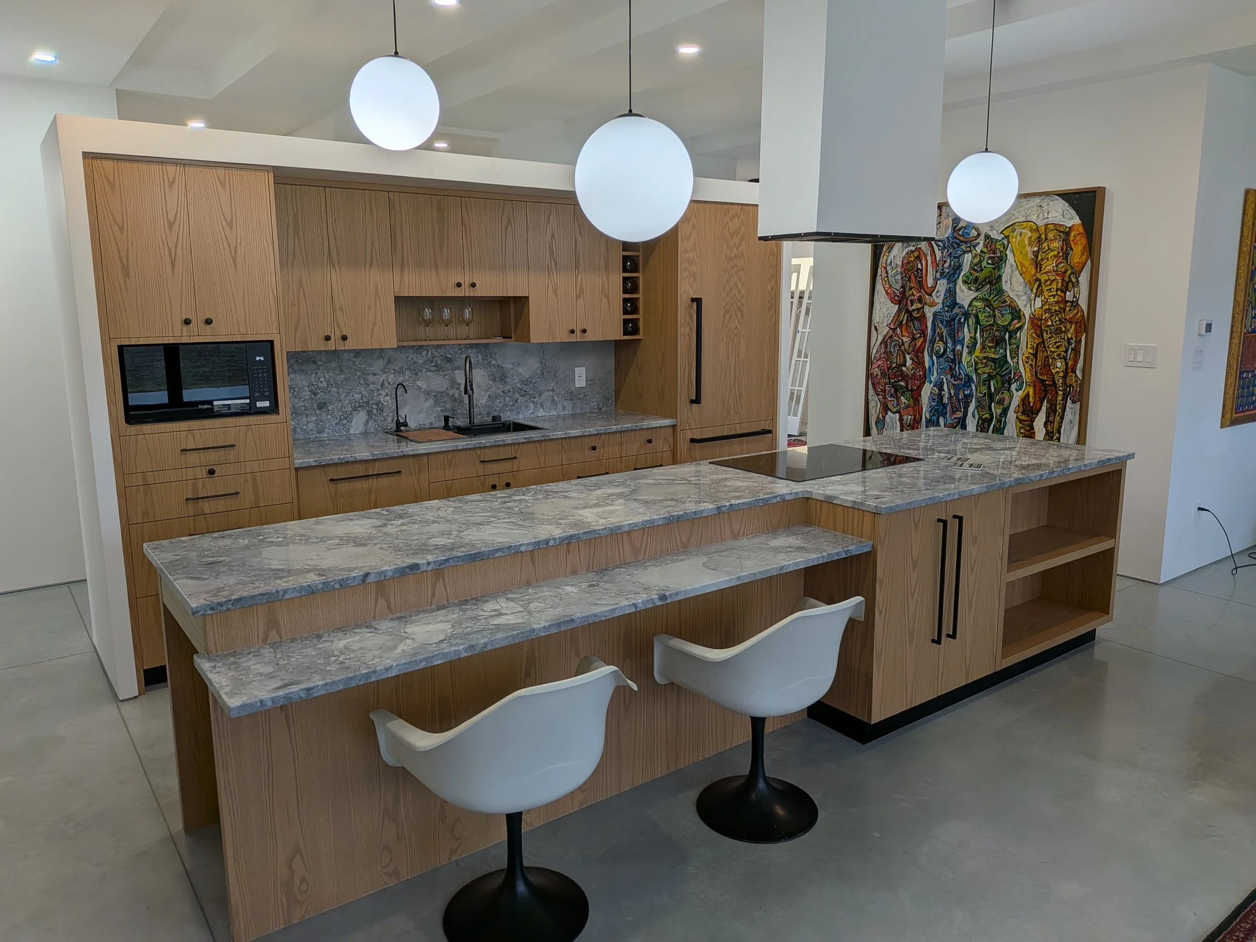 Red Oak slab doors, appliance panels, custom build and fit. Butcher block cutting board below microwave.