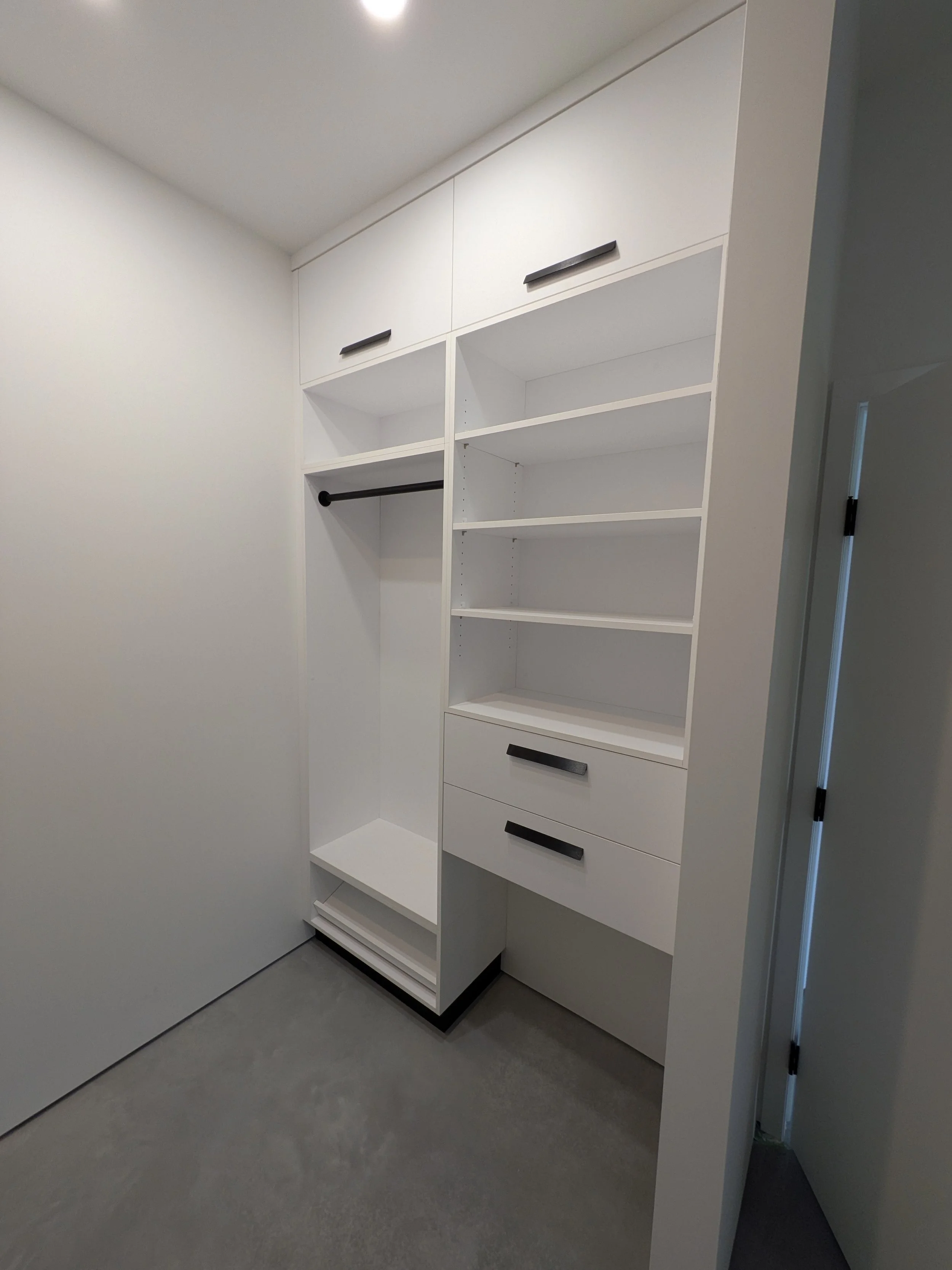 Her Closet (right), shoe storage at bottom, space for rolling hamper on right.