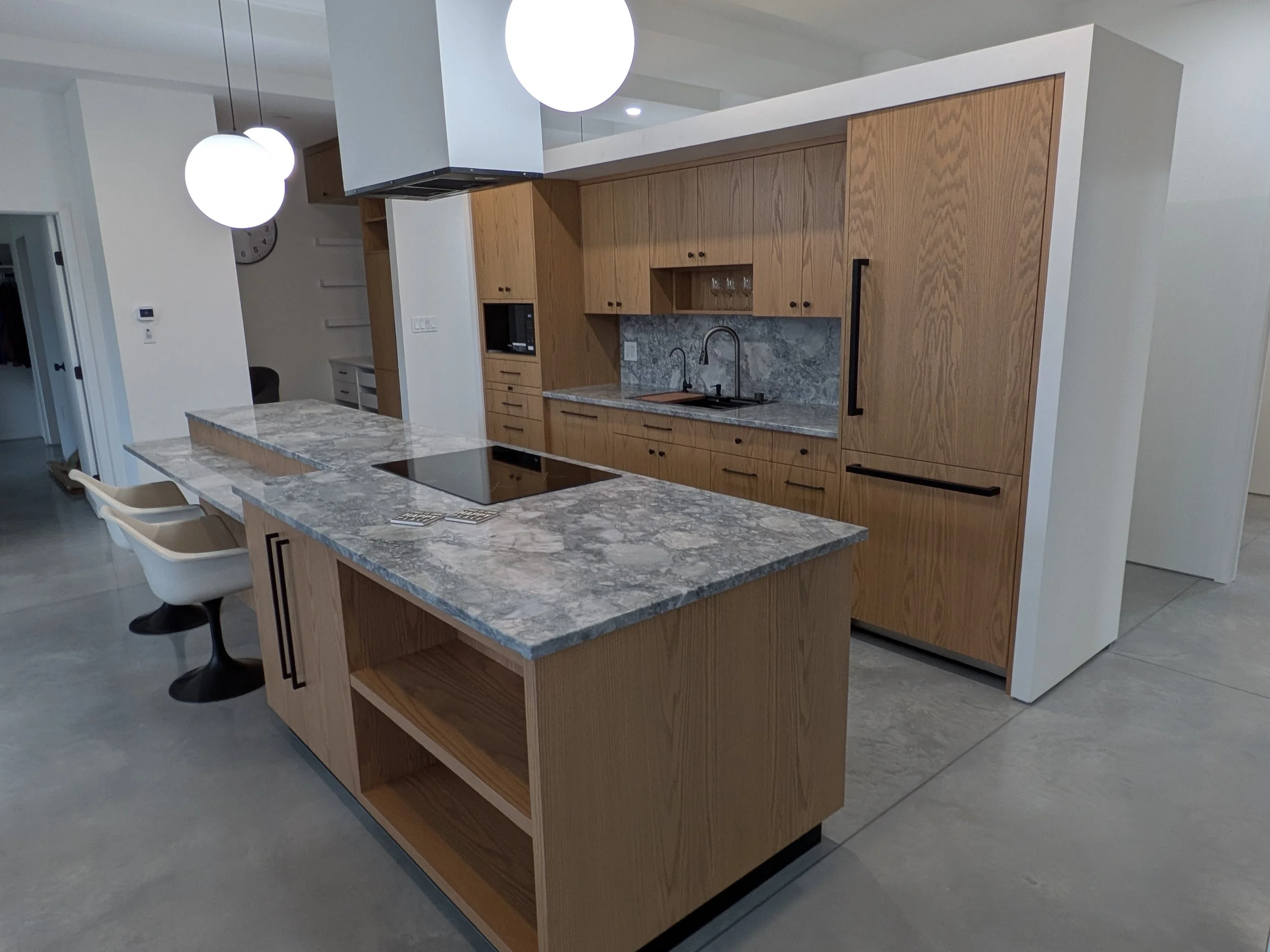 Red Oak slab doors, appliance panels, custom build and fit. Butcher block cutting board below microwave.