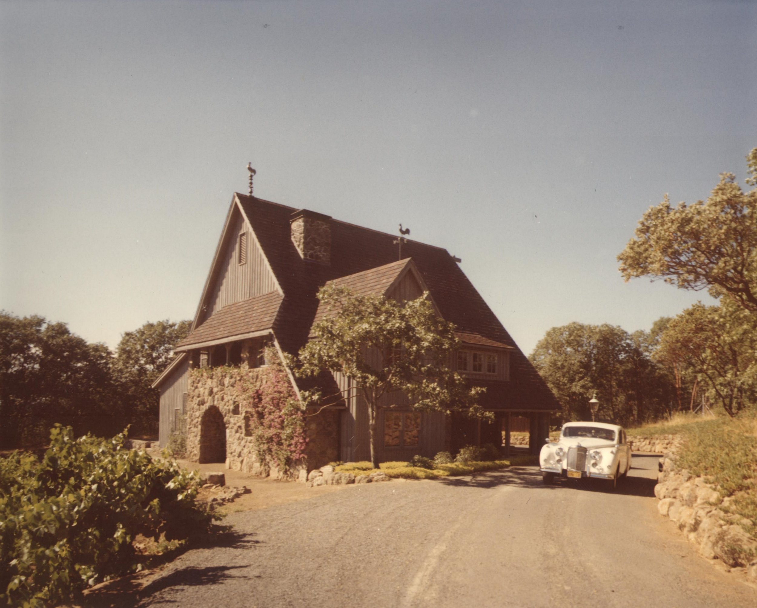 Photo of Hanzell Winery with white rolls royce in driveway in 1950s