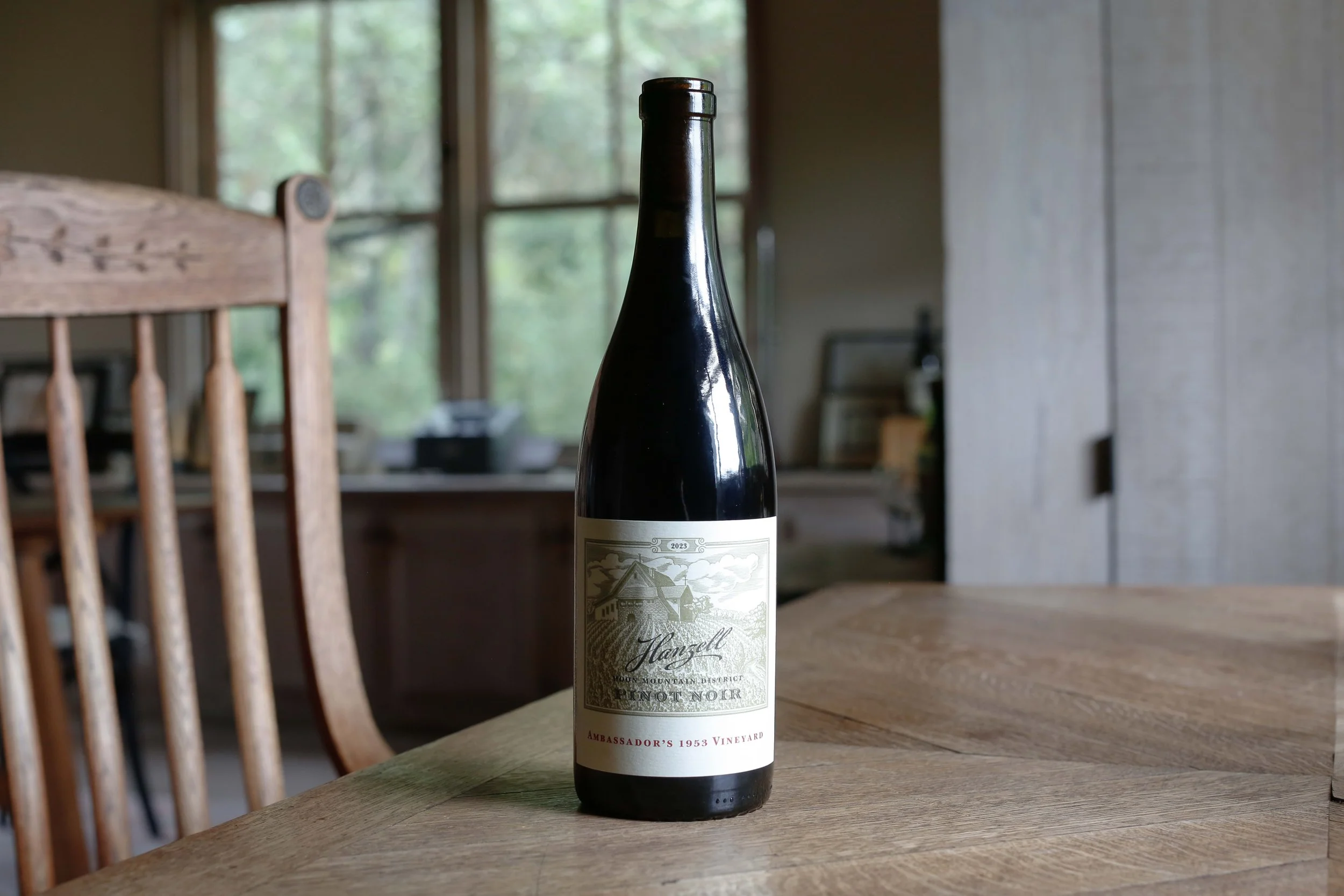Bottle of 2023 Hanzell Pinot Noir, Ambassador's 1953 Vineyard sitting on desk
