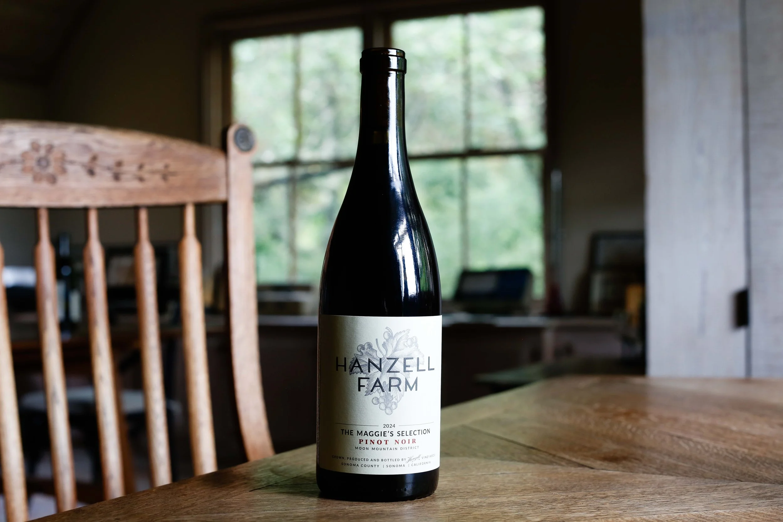 Bottle of Hanzell Farm Pinot Noir, The Maggie's Selection sitting on a desk