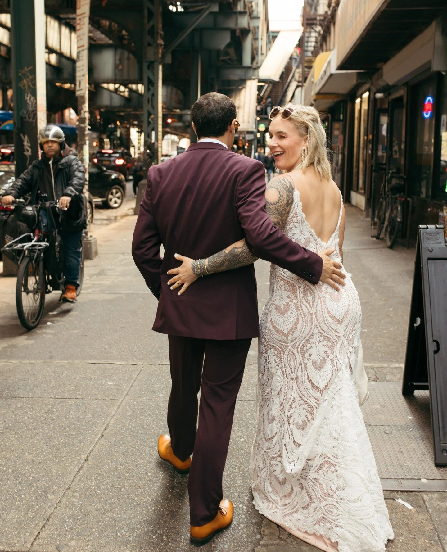 Zach and Kenzie feeling cheeky on their pre-ceremony stroll through Brooklyn. 😉⁠
⁠
The couple premiered their stunning wedding attire on Broadway in Bushwick before hitching a ride on the J train to the East Village. Other locations from the day inc