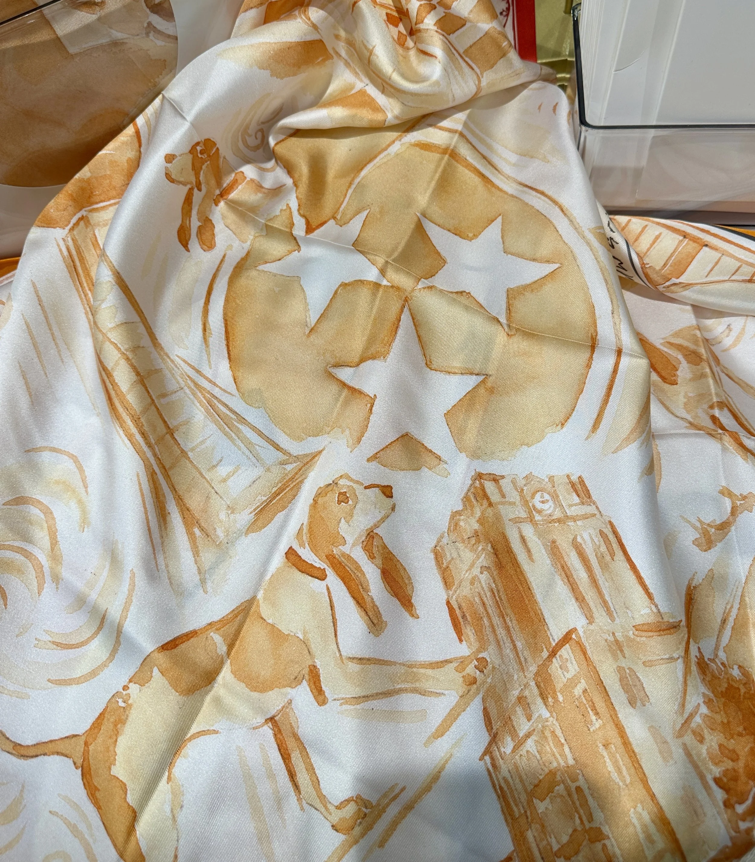 Tennessee watercolor silk scarf by Megan Grinder, shown on the diamond, with Neyland Stadium and the Torchbearer in orange inside a star border