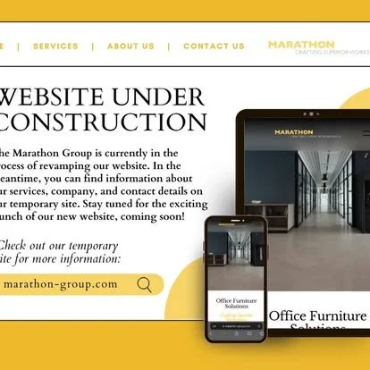 Marathon Group website under construction with a computer and smartphone showing office furniture solutions, and a yellow banner with a website URL for more info.