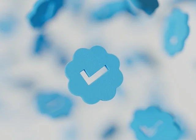 Blue confirmation checkmark pin on a blurred background of similar pins.