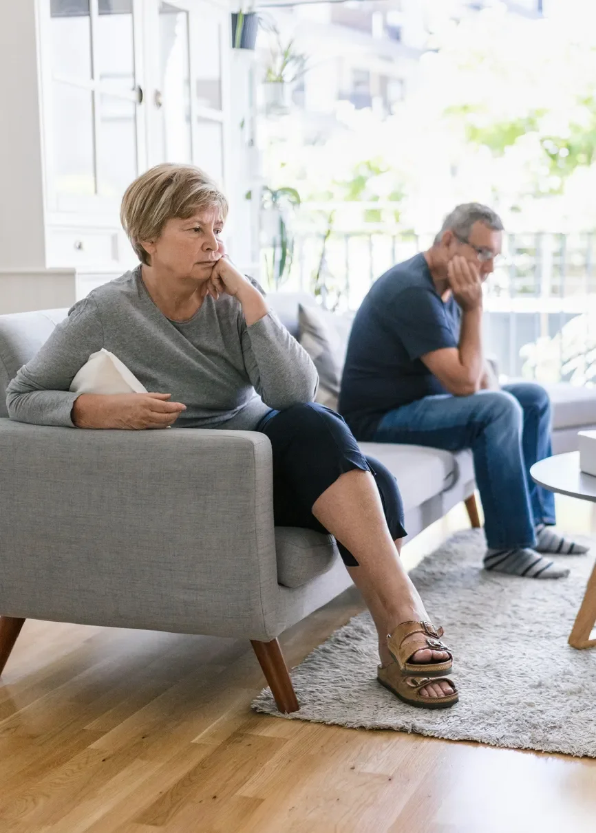 couple on sofa looking angry with each other