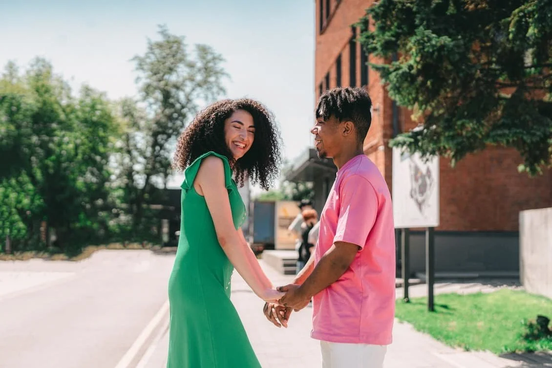 happy-couple-standing-while-holding-hands