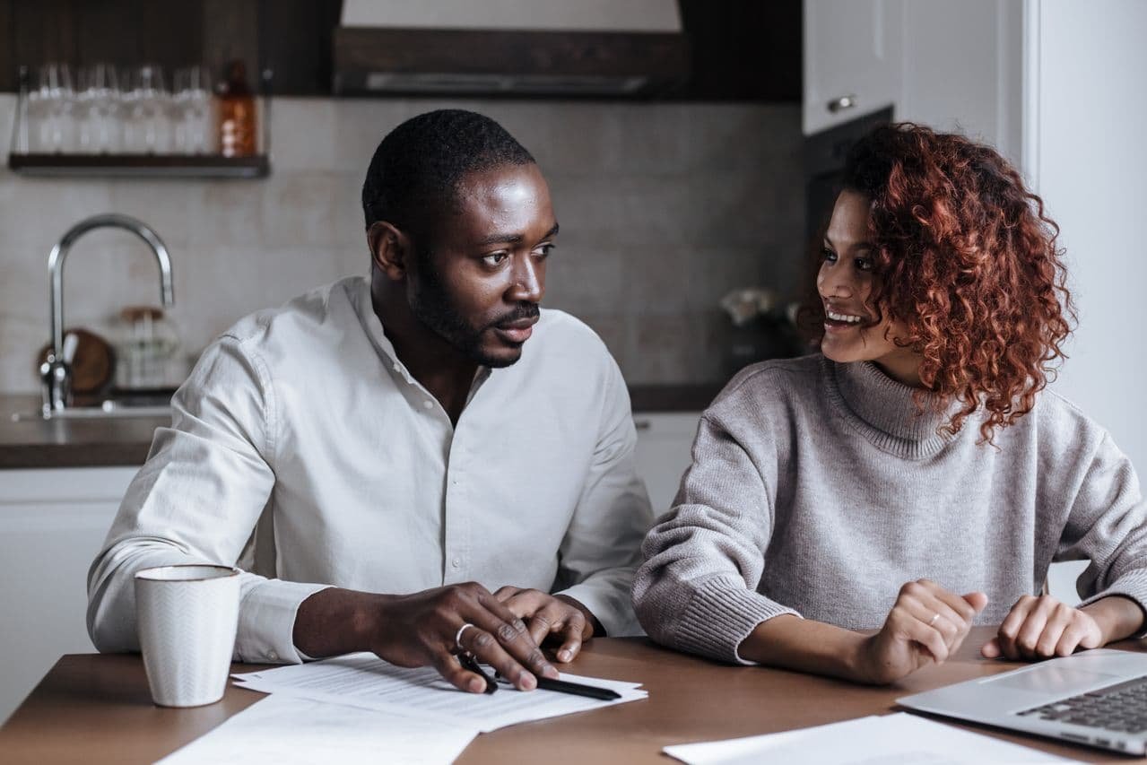 couple-sitting-in-front-of-laptop-at-home