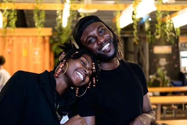 a-man-and-a-woman-are-smiling-for-the-camera