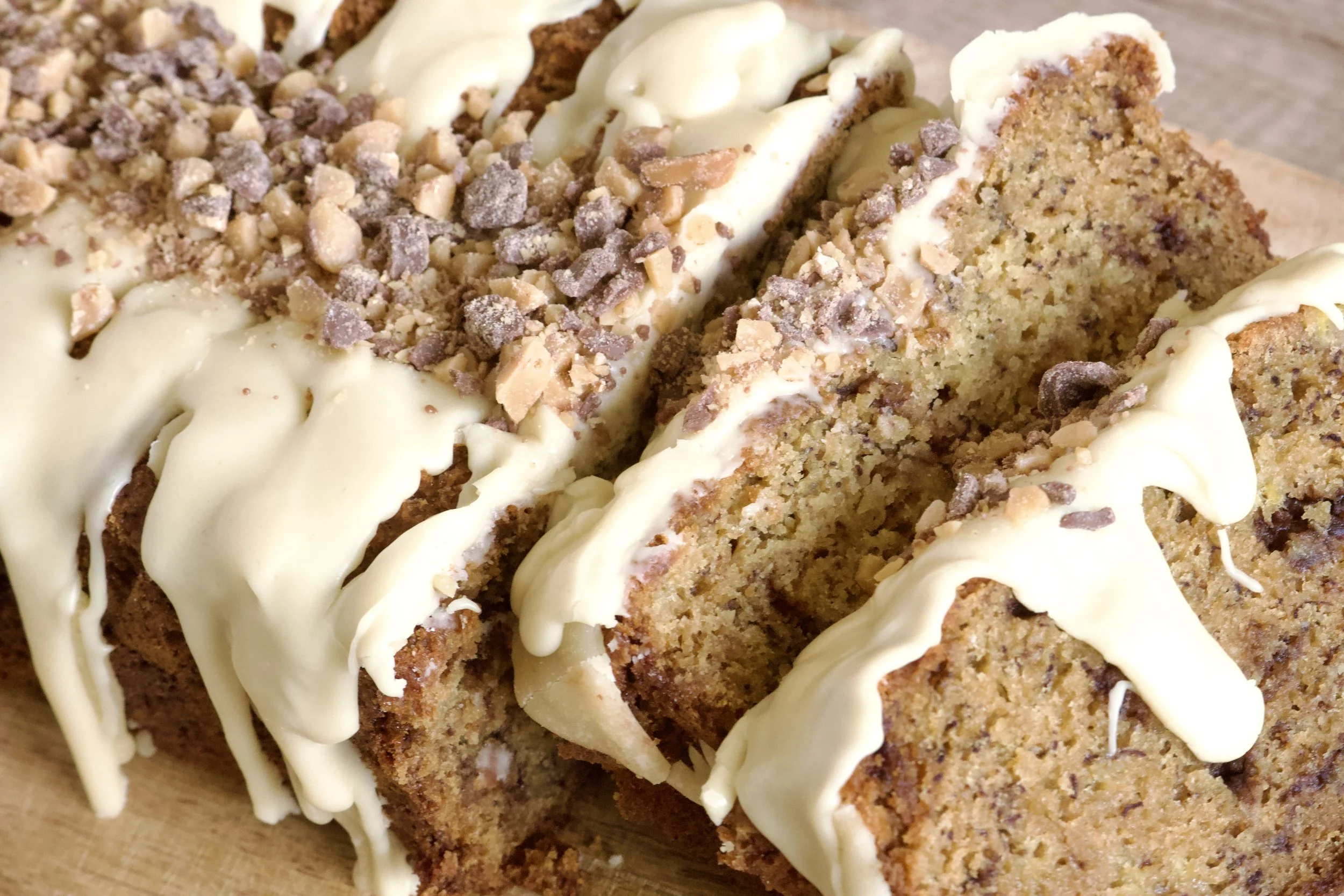 thick and moist banana bread with toffee bits and caramely icing