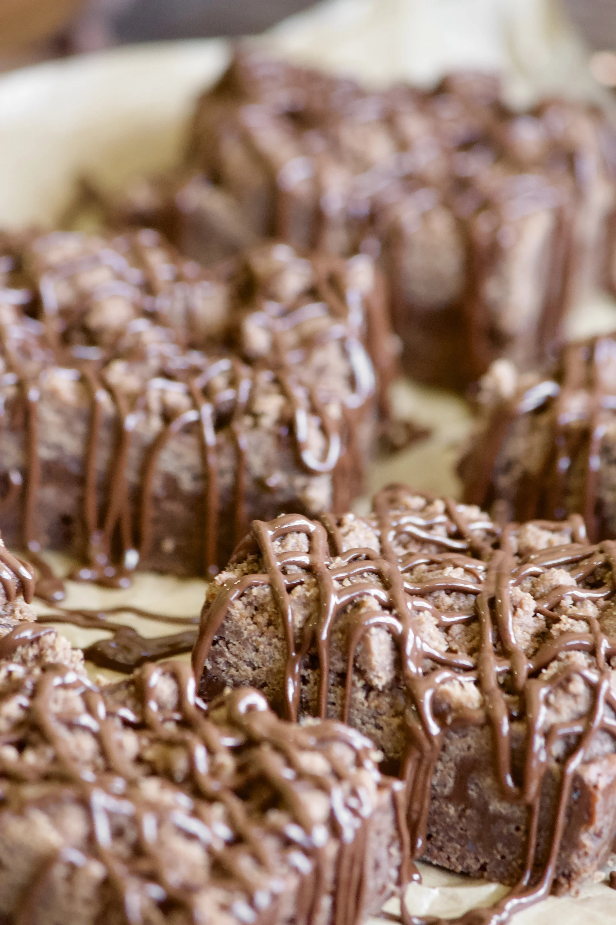 chocolate cookie bars with fudge filling and chocolate drizzle
