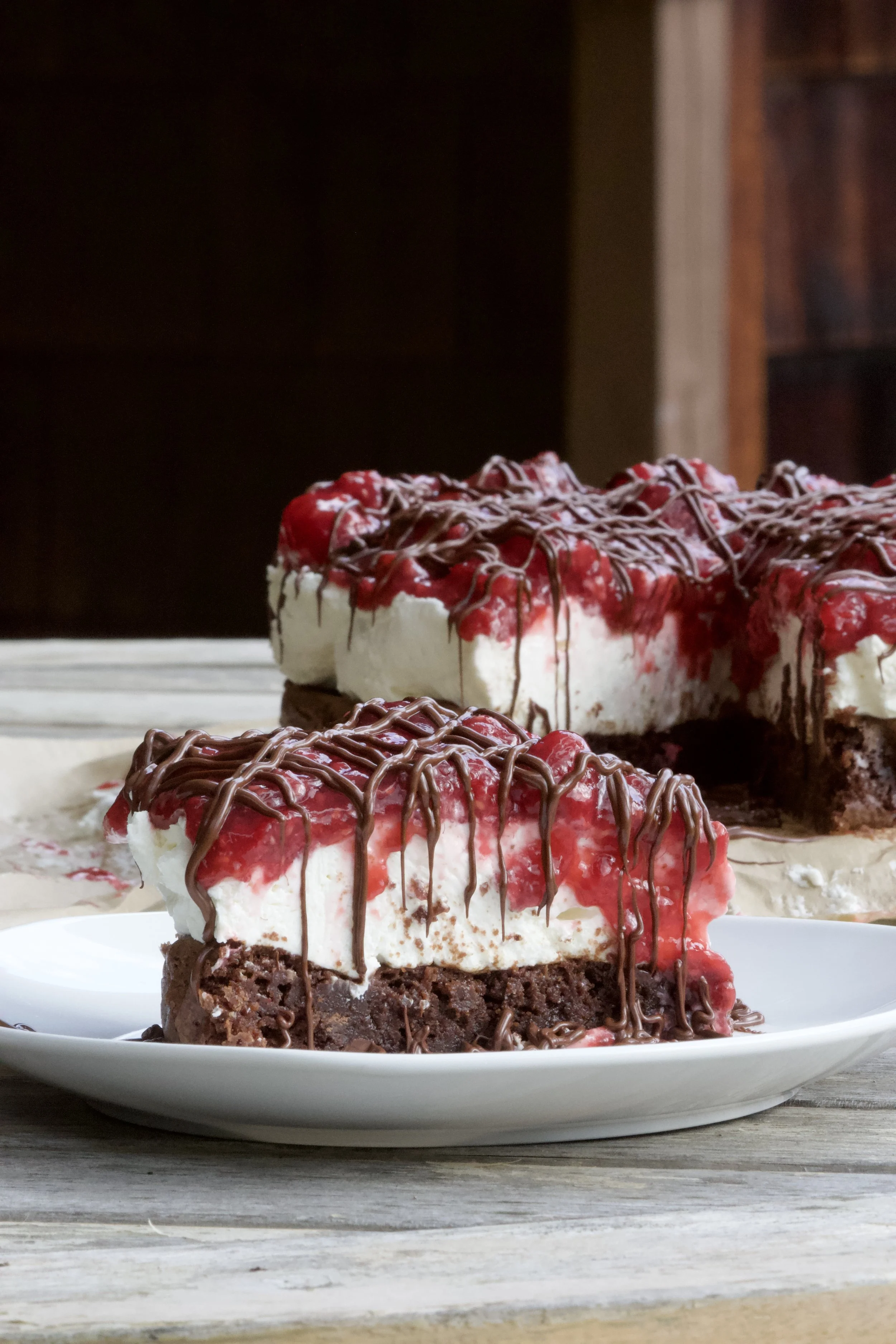 cheesecake with chocolate and raspberries. brownies on bottom