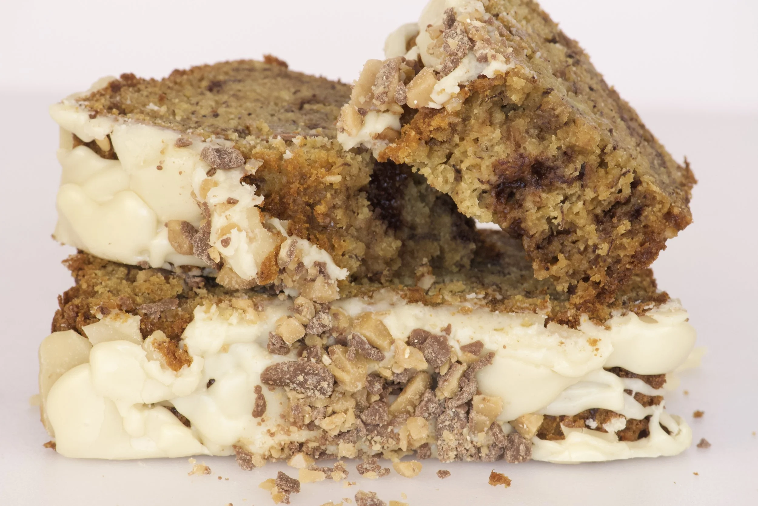 banana toffee loaf with brown sugar icing and pieces of crunchy toffee