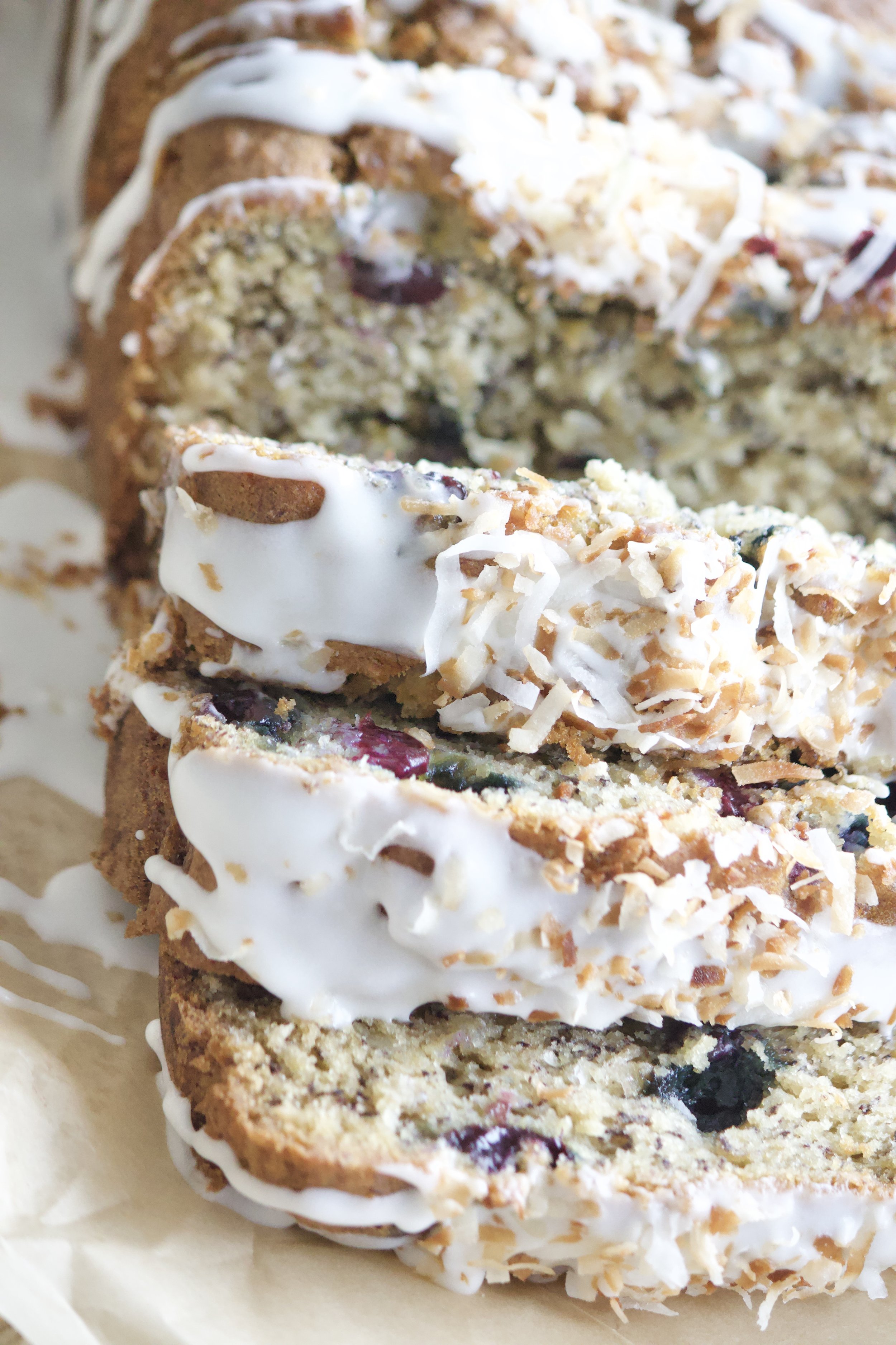banana blueberry coconut loaf with vanilla glaze and toasted coconut