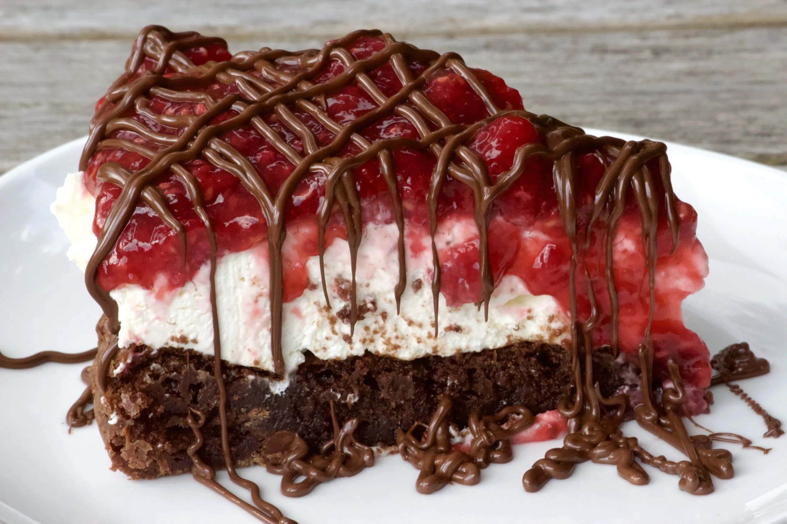 gluten-free brownie with cheesecake and raspberry topping