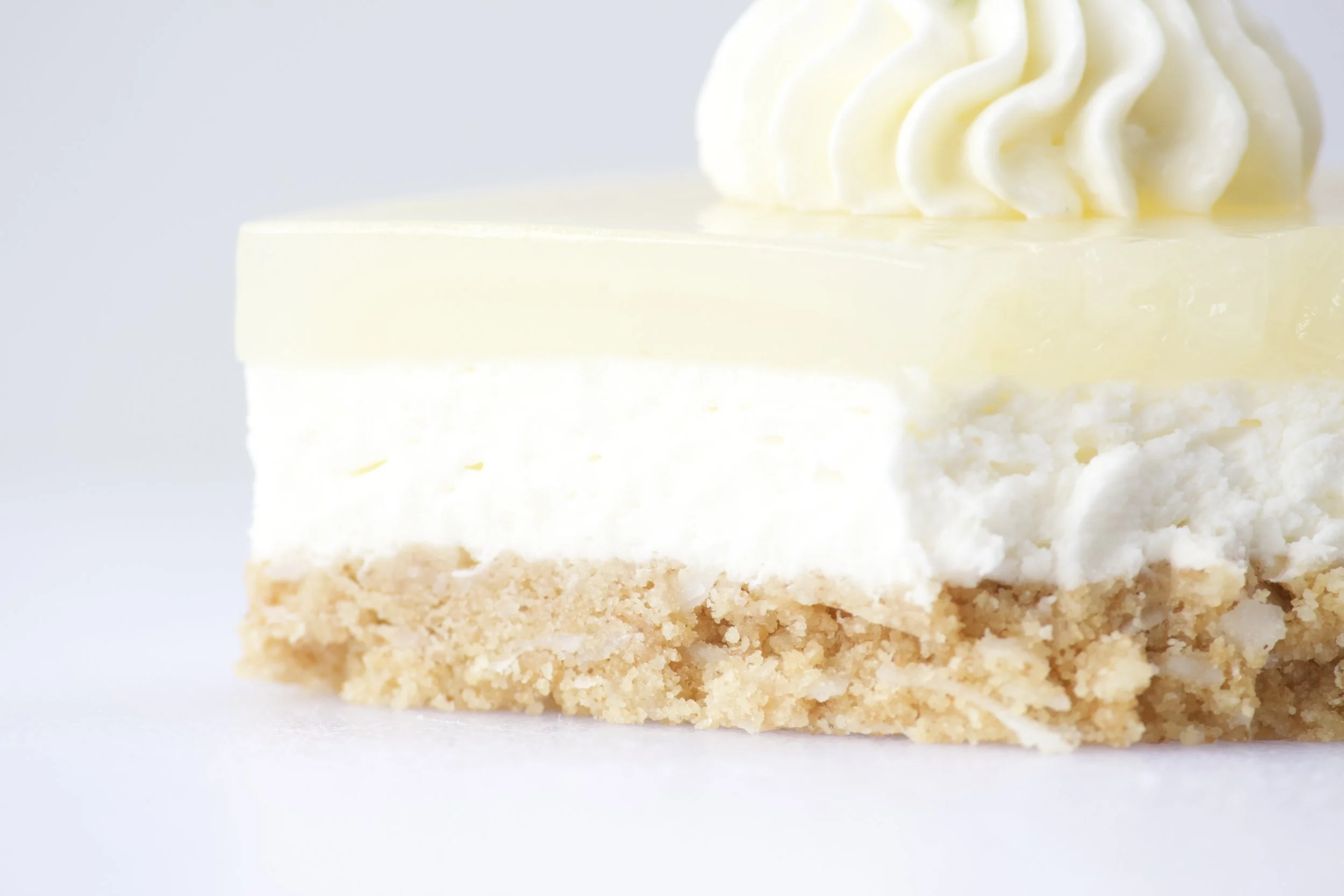 three layer key lime pie dessert with coconut and rum