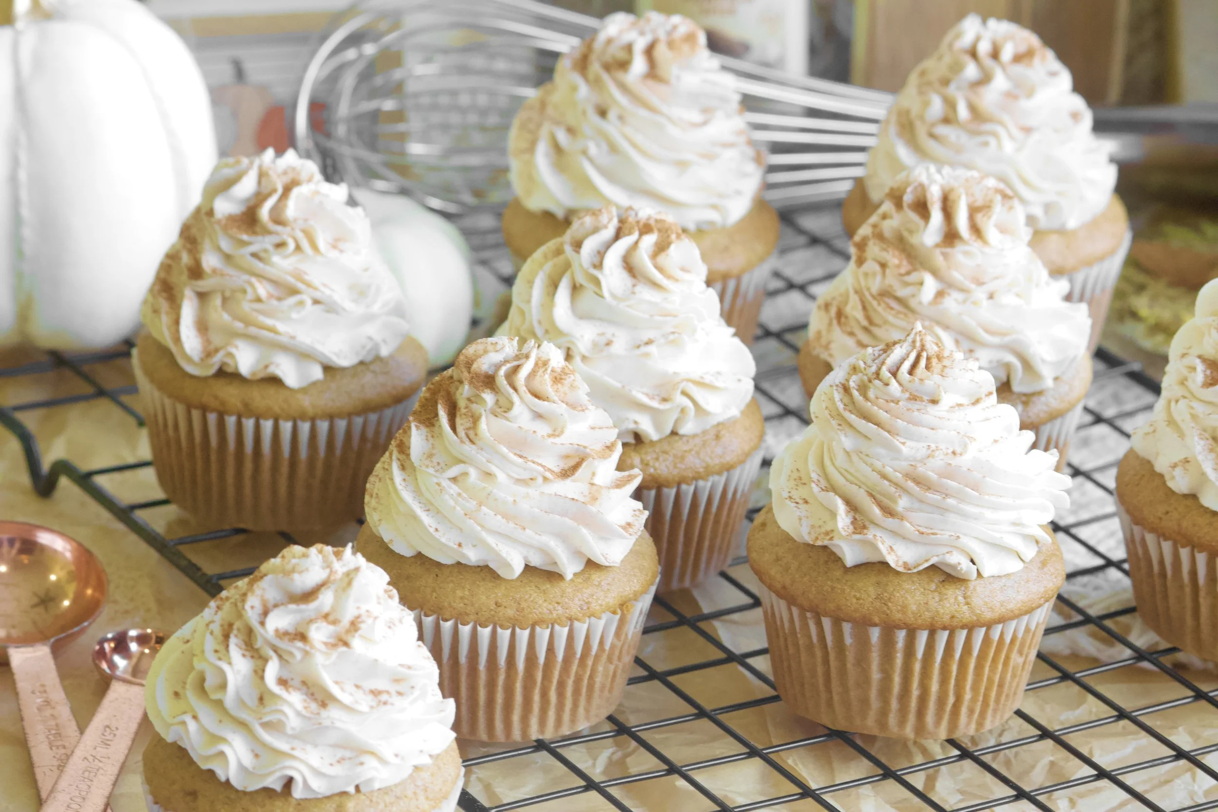 pumpkin cupcakes with white frosting and cinnamon