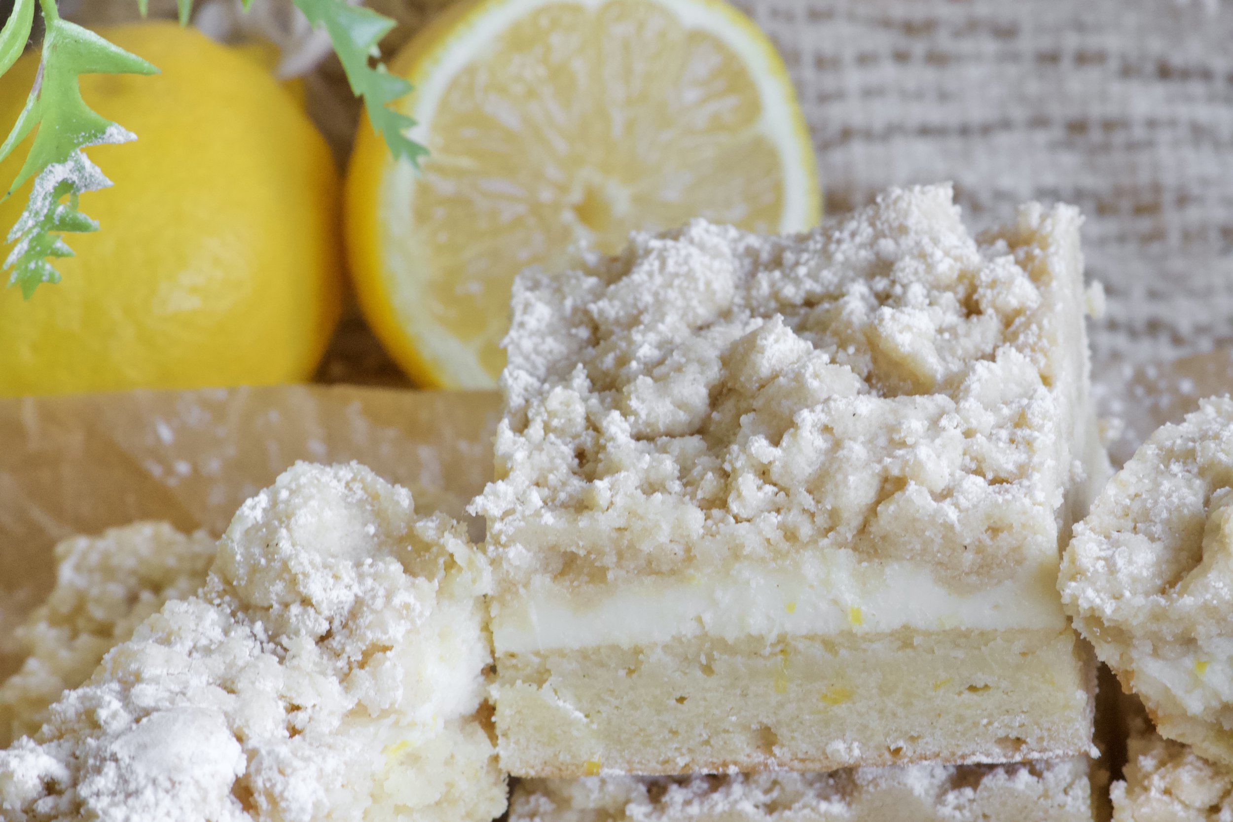 lemon custard crumb bar gluten free with powdered sugar and fresh lemons