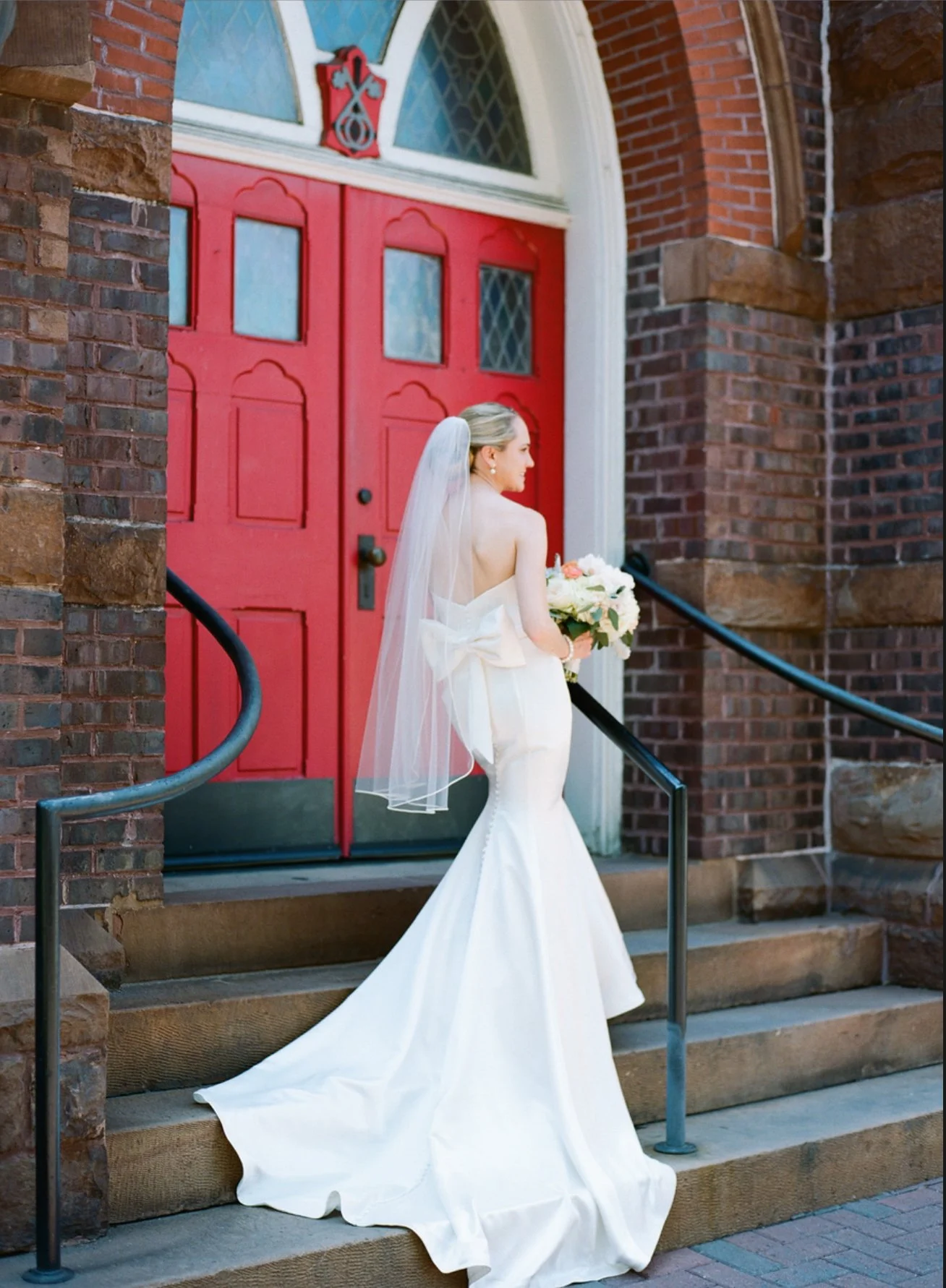 Bride in front of red door