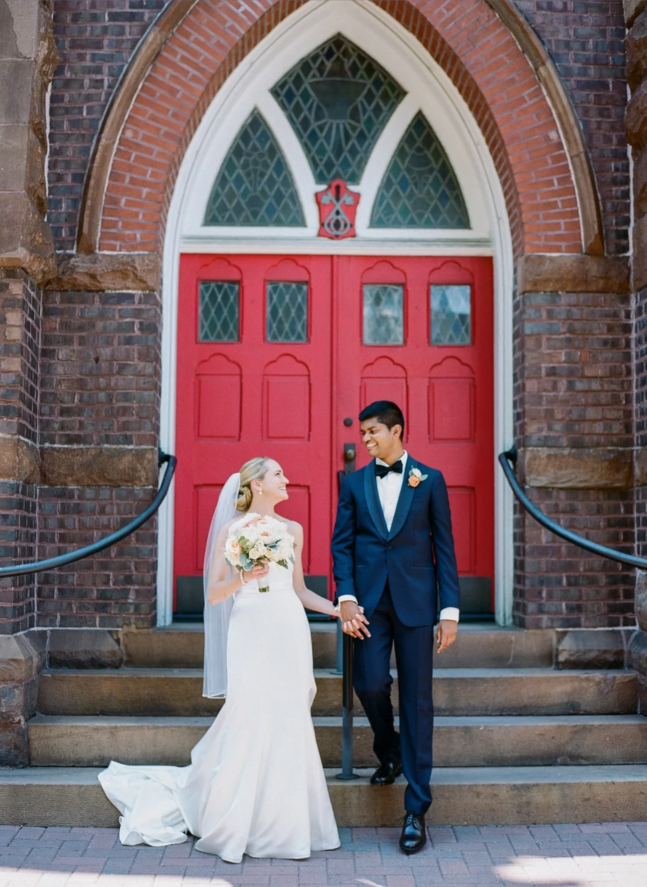 Wedding photo in front of red door