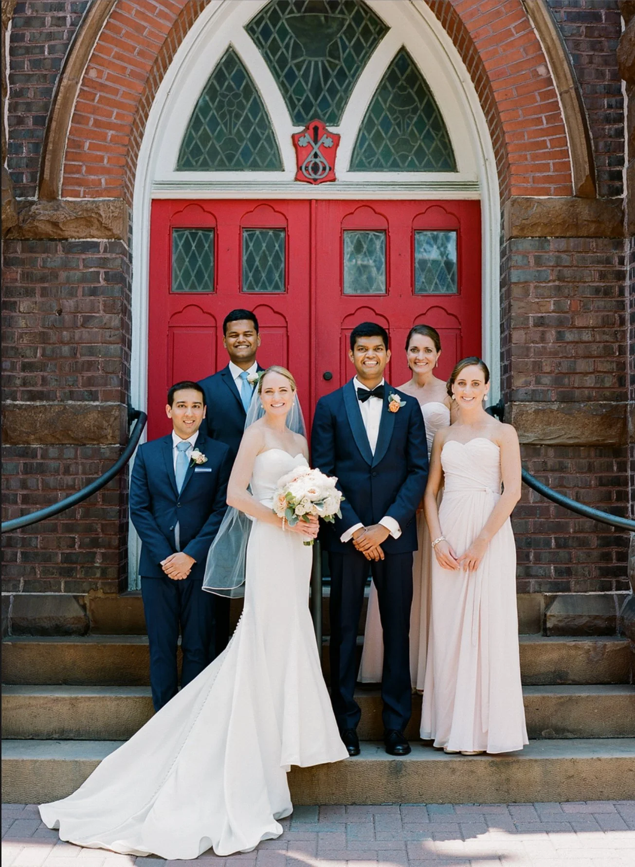 Wedding party in front of red door