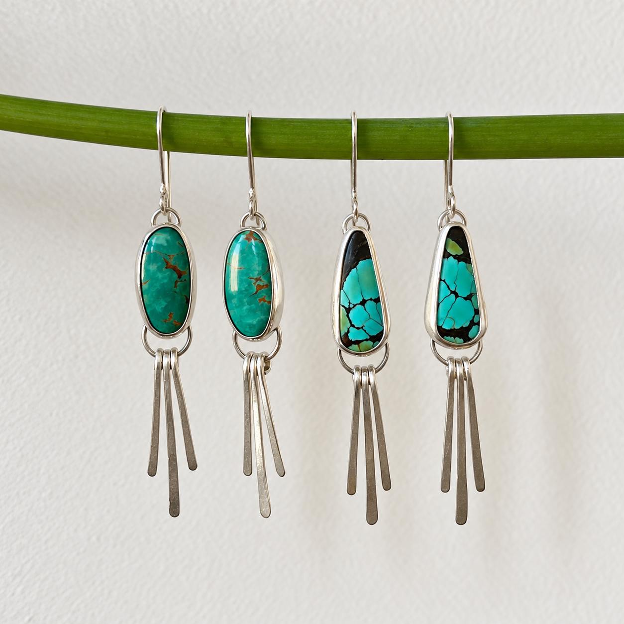 Four Turquoise Earrings on a Green Stem.png