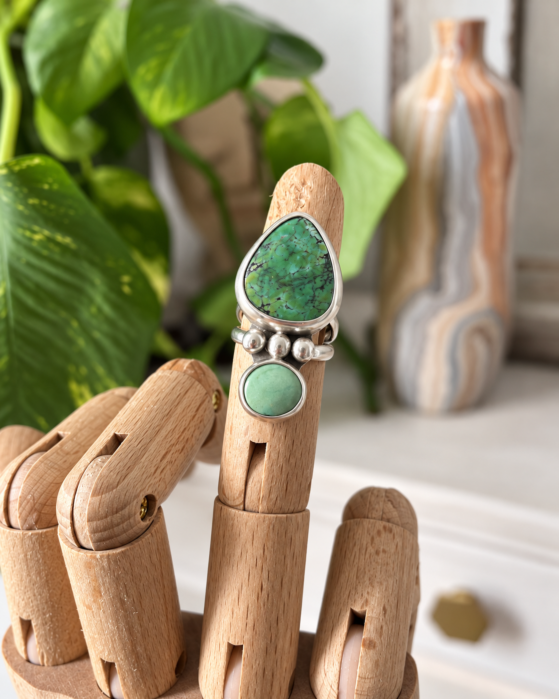 Handmade turquoise ring on wooden hand (1).png .png
