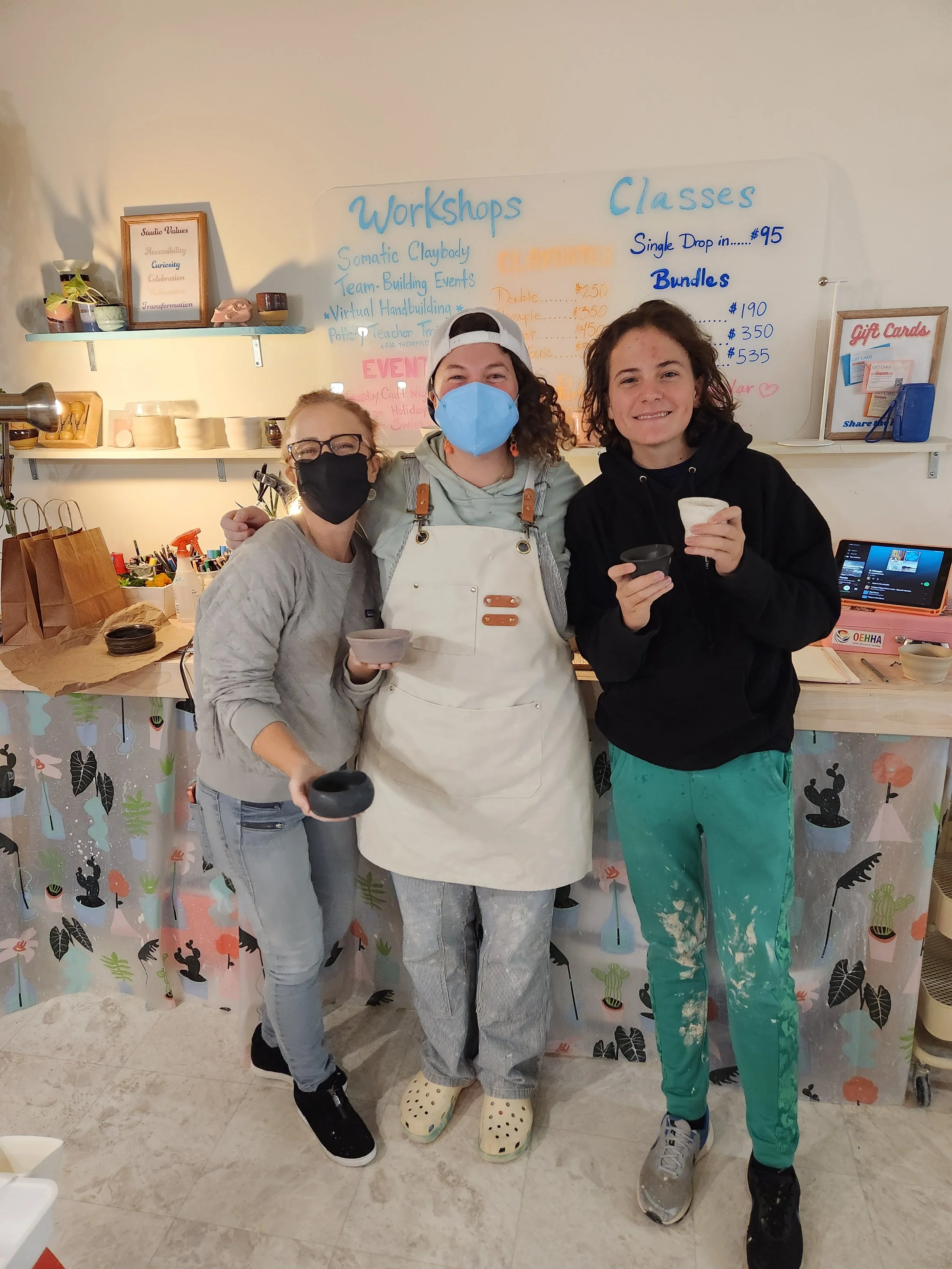 Family members learn to throw and trim their work, taking an introductory pottery class