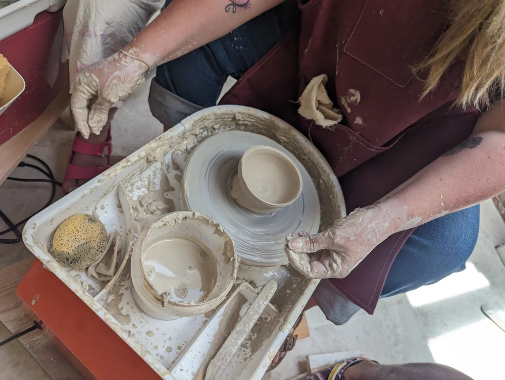 Beginner throwing with clay in the pottery studio