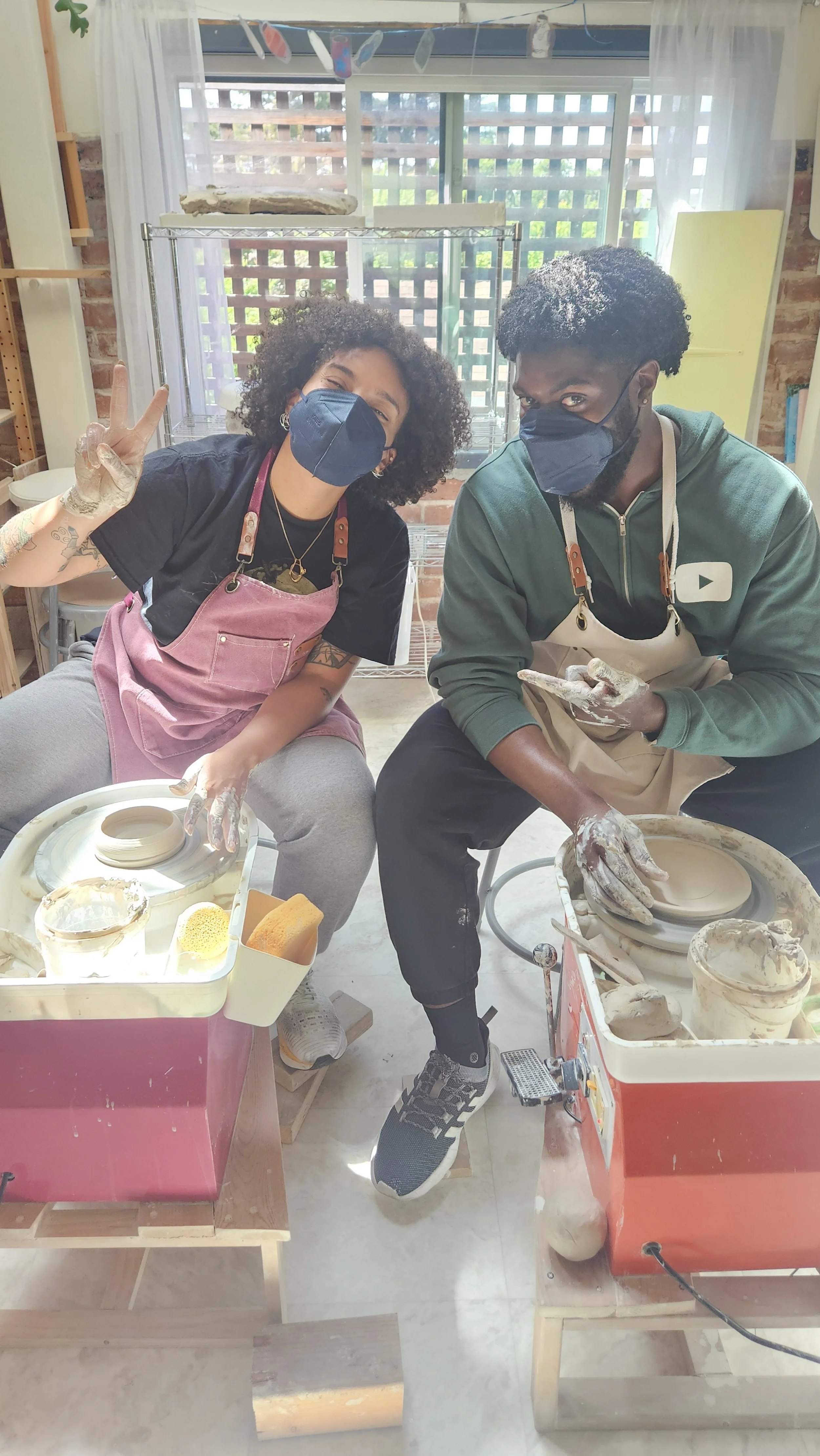  Two students enjoying a creative date night in the pottery studio 