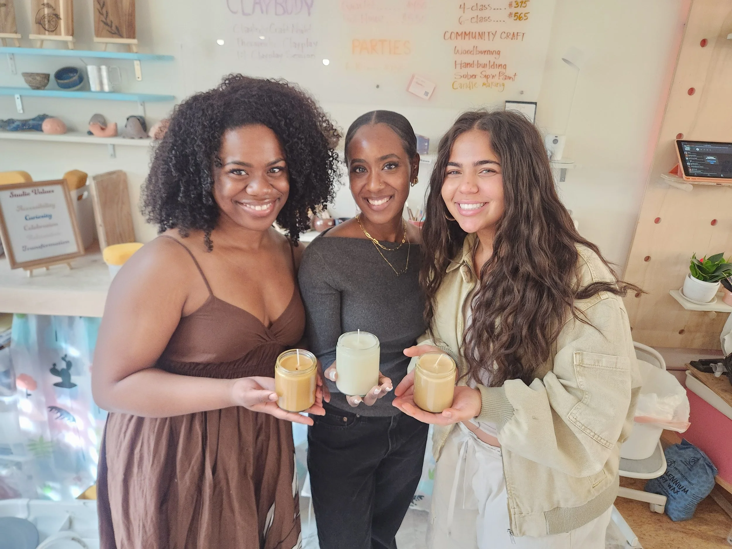  Three friends with their homemade, custom candles from a candle-making workshop! Their fragrance blends were jasmine, cinnamon and redwood forest. 