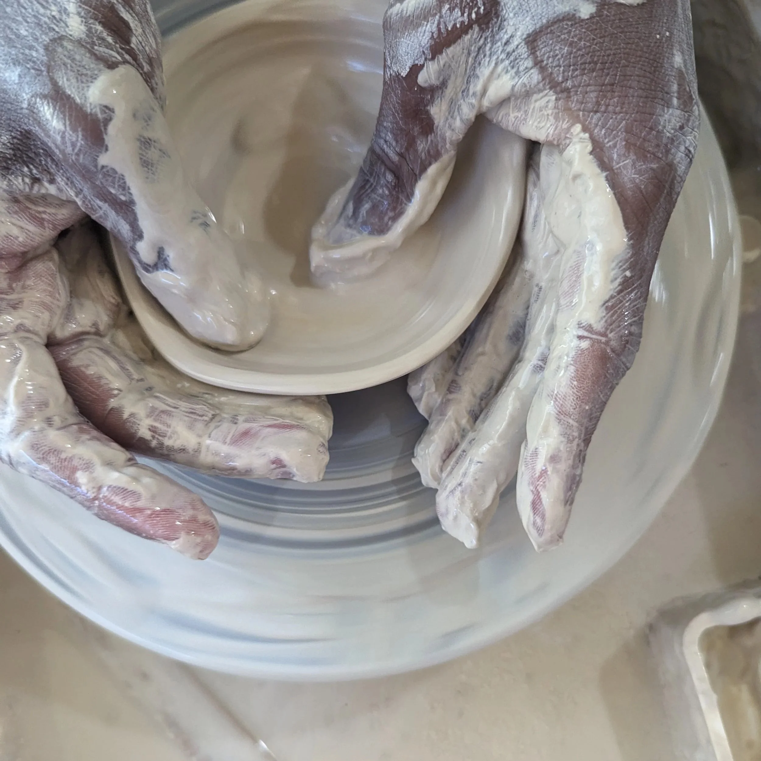 Calming clay class where beginners play and reset nervous system in pottery studio