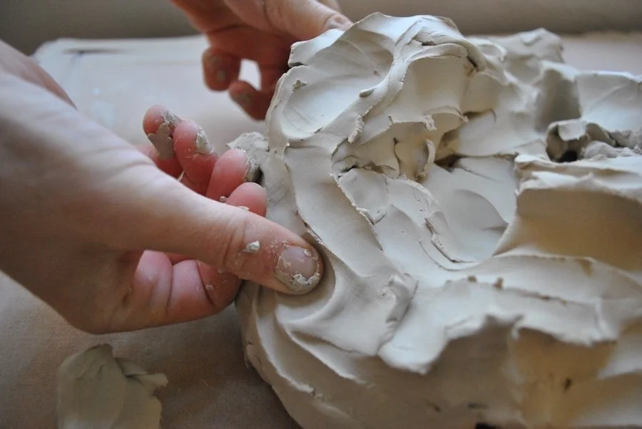 Hands play with clay at an introductory ceramic workshop in Berkeley
