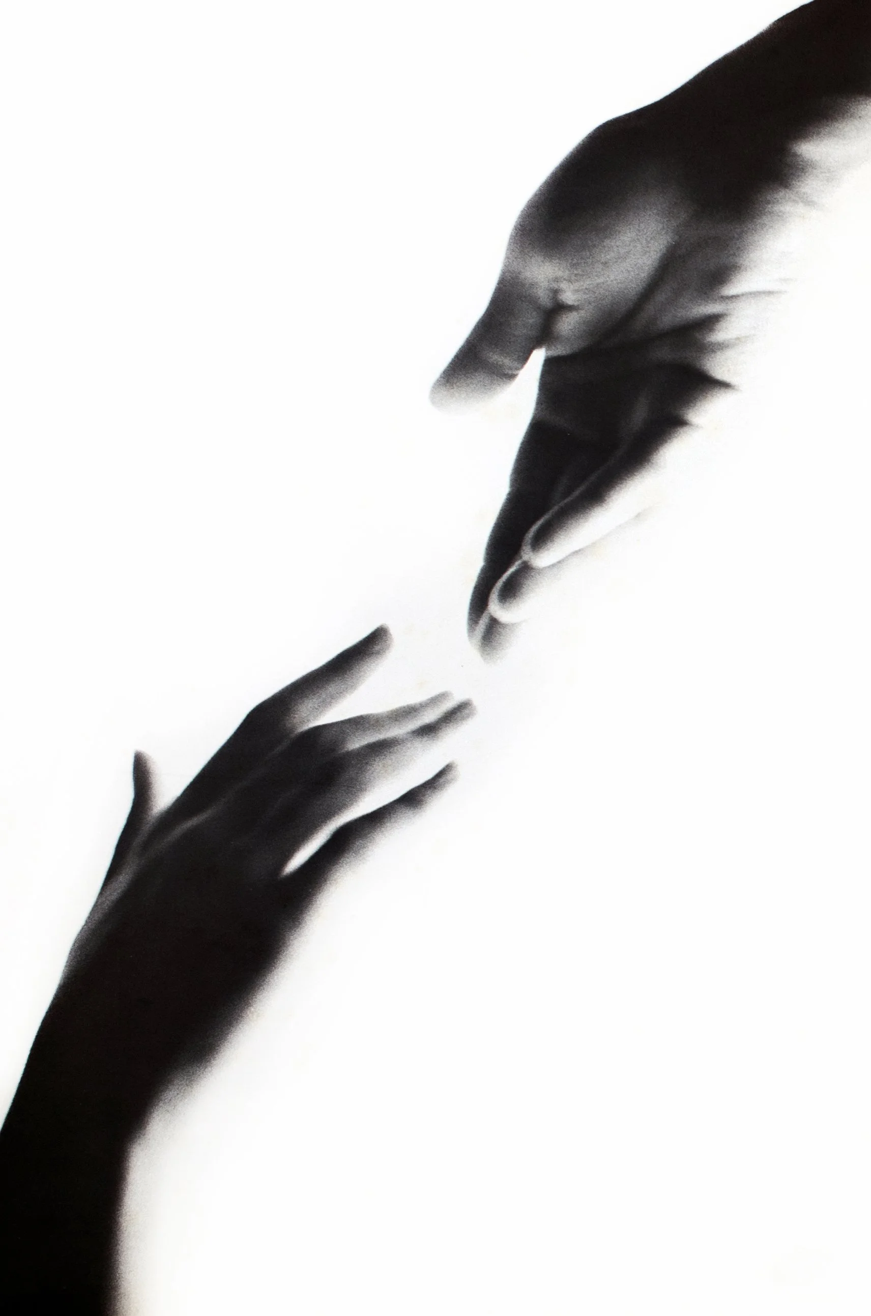 Black and white photograph of two hands reaching towards each other, one larger and one smaller, against a white background, symbolizing connection or help.