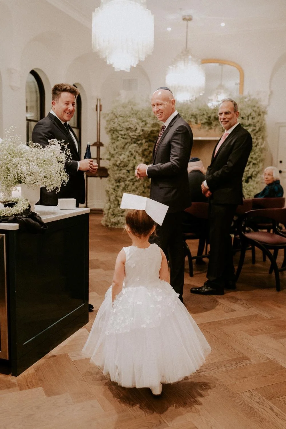 flower-girl-balances-a-napking-on-her-head-in-private-suite-at-riggs-hotel.jpg.jpg