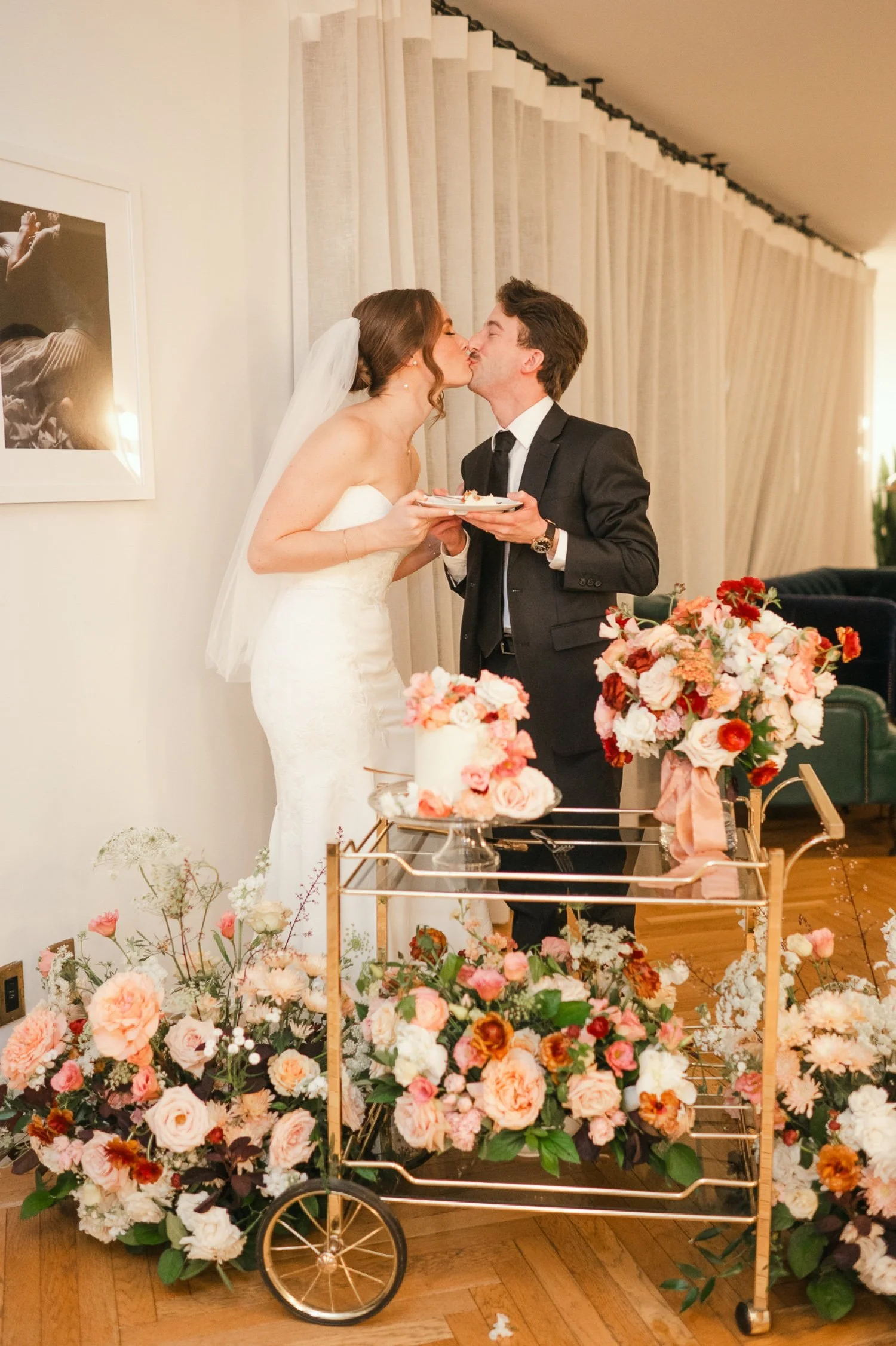 bride-and-groom-kiss-while-cutting-their-cake-at-small-intimate-dinner-in-the-monument-suite-of-the-line-hotel.jpg.jpg