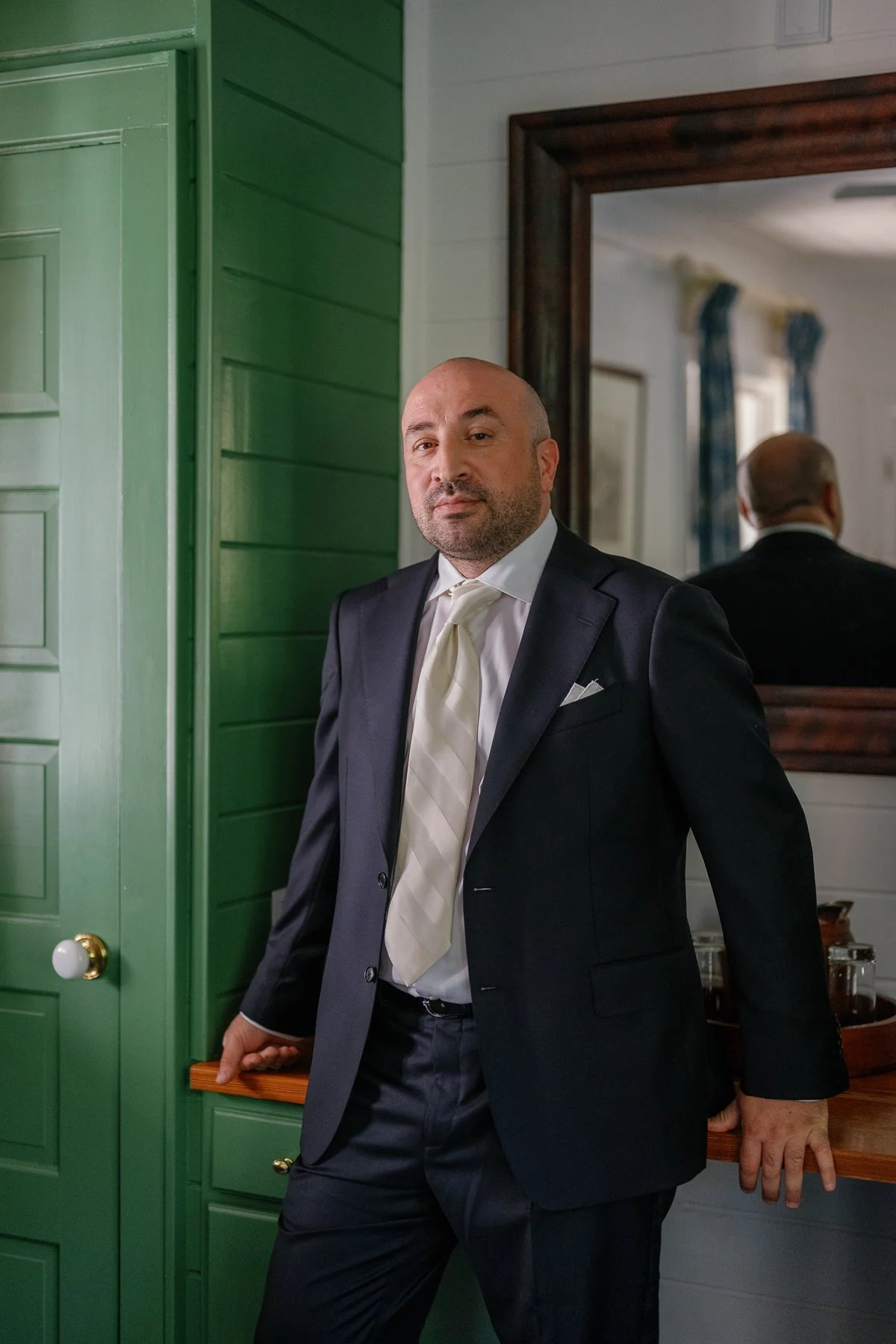  Wedding portrait in a navy suit and ivory tie at Goodstone Inn in Middleburg, Virginia 
