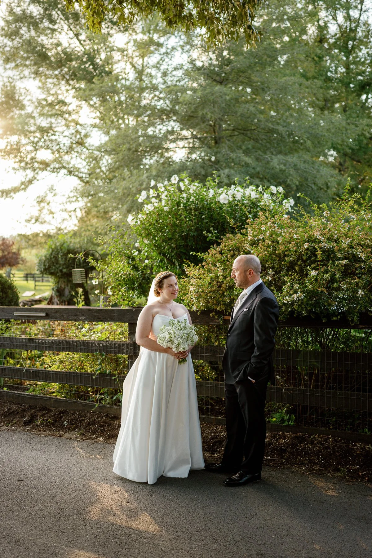  Couple portrait by the garden fence at golden hour, Goodstone Inn Middleburg VA 