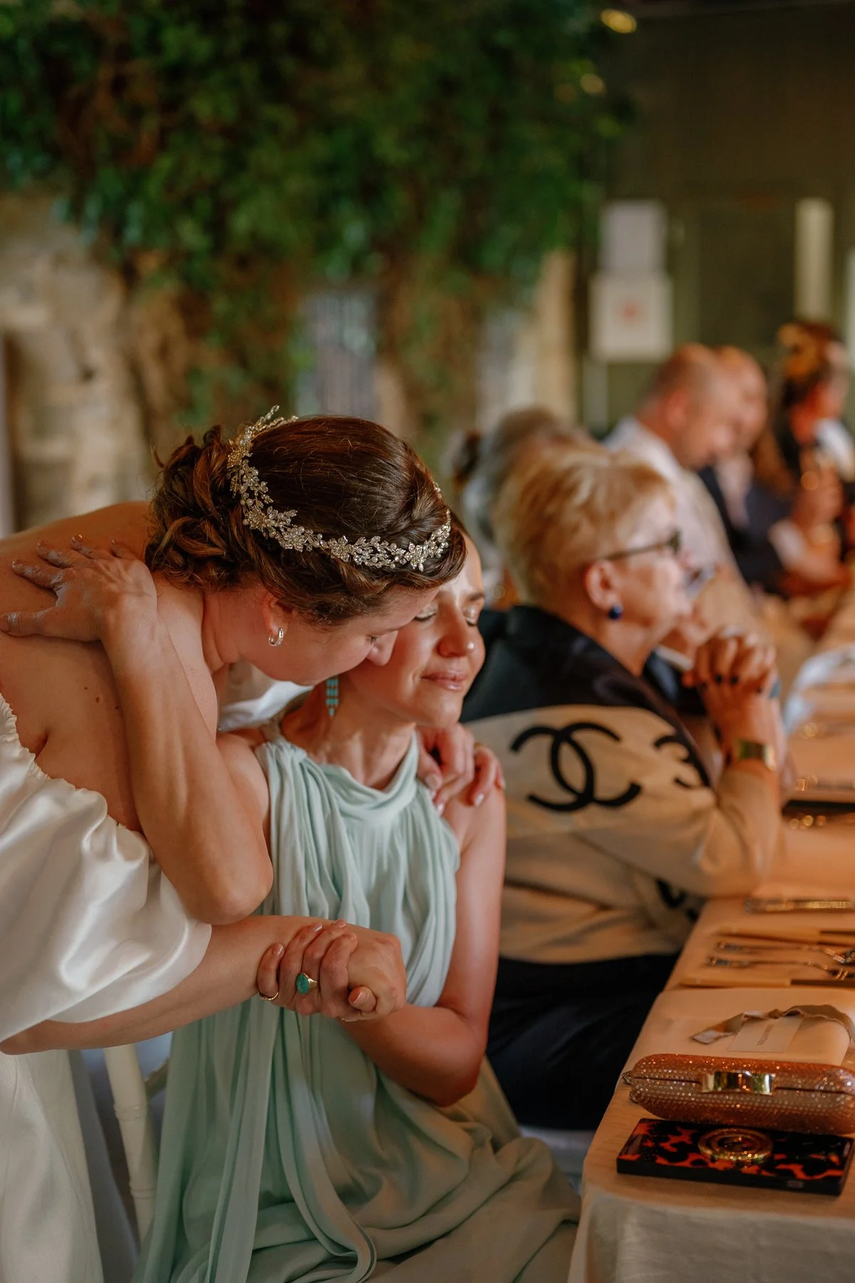  Couple hugging the maid of honor during dinner at Goodstone Inn 