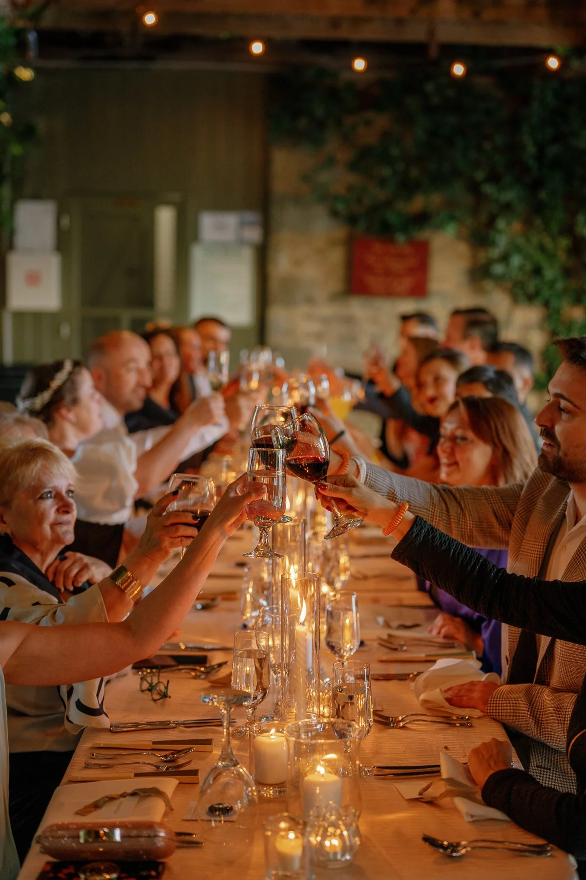  Guests raising glasses at a long-table micro wedding dinner at Goodstone Inn 