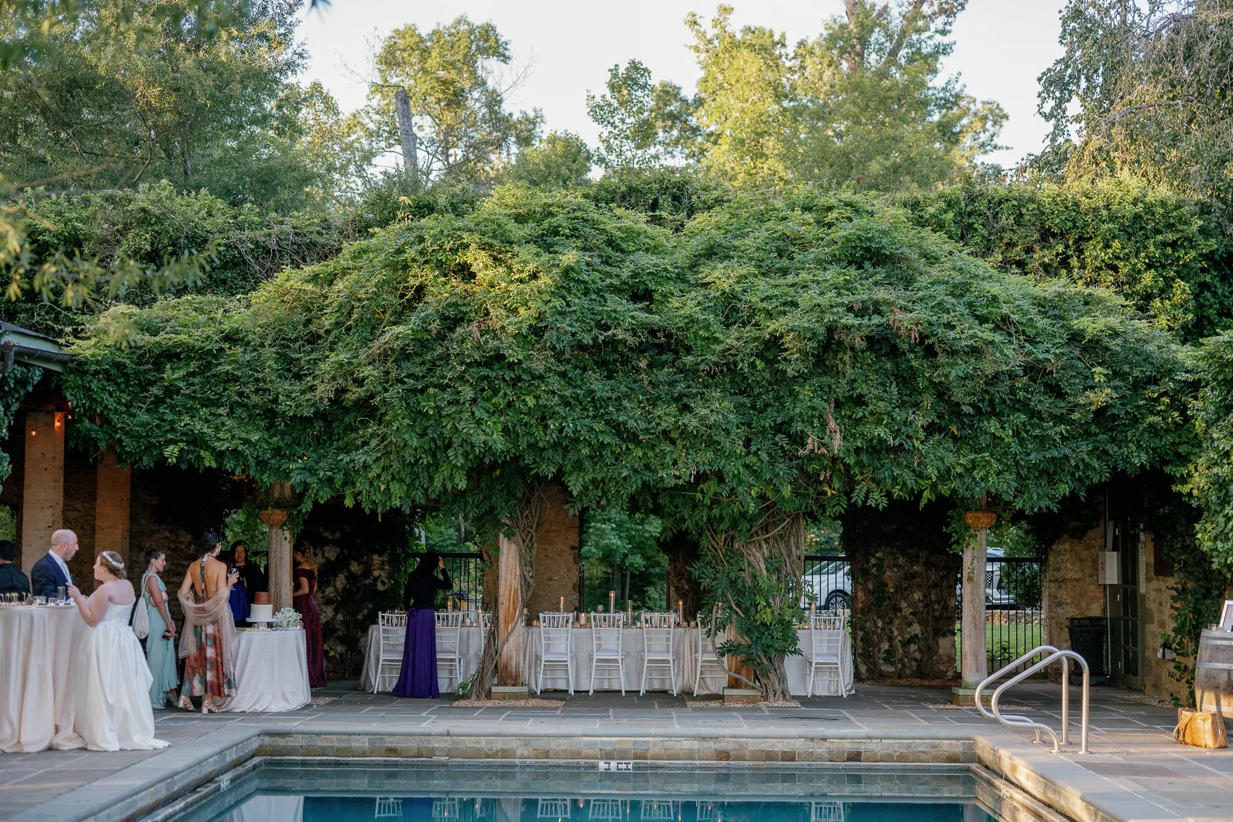 Poolside cocktail hour and pergola dinner at a Goodstone Inn micro wedding