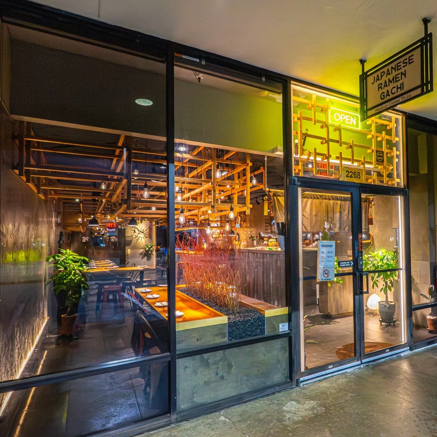 Under the wooden grid, we serve more than just noodles. We serve a moment. 🍜

The intricate timber framework above you isn't polished to perfection. It is intentionally rough and raw. It echoes the scaffolding of something under construction or the 