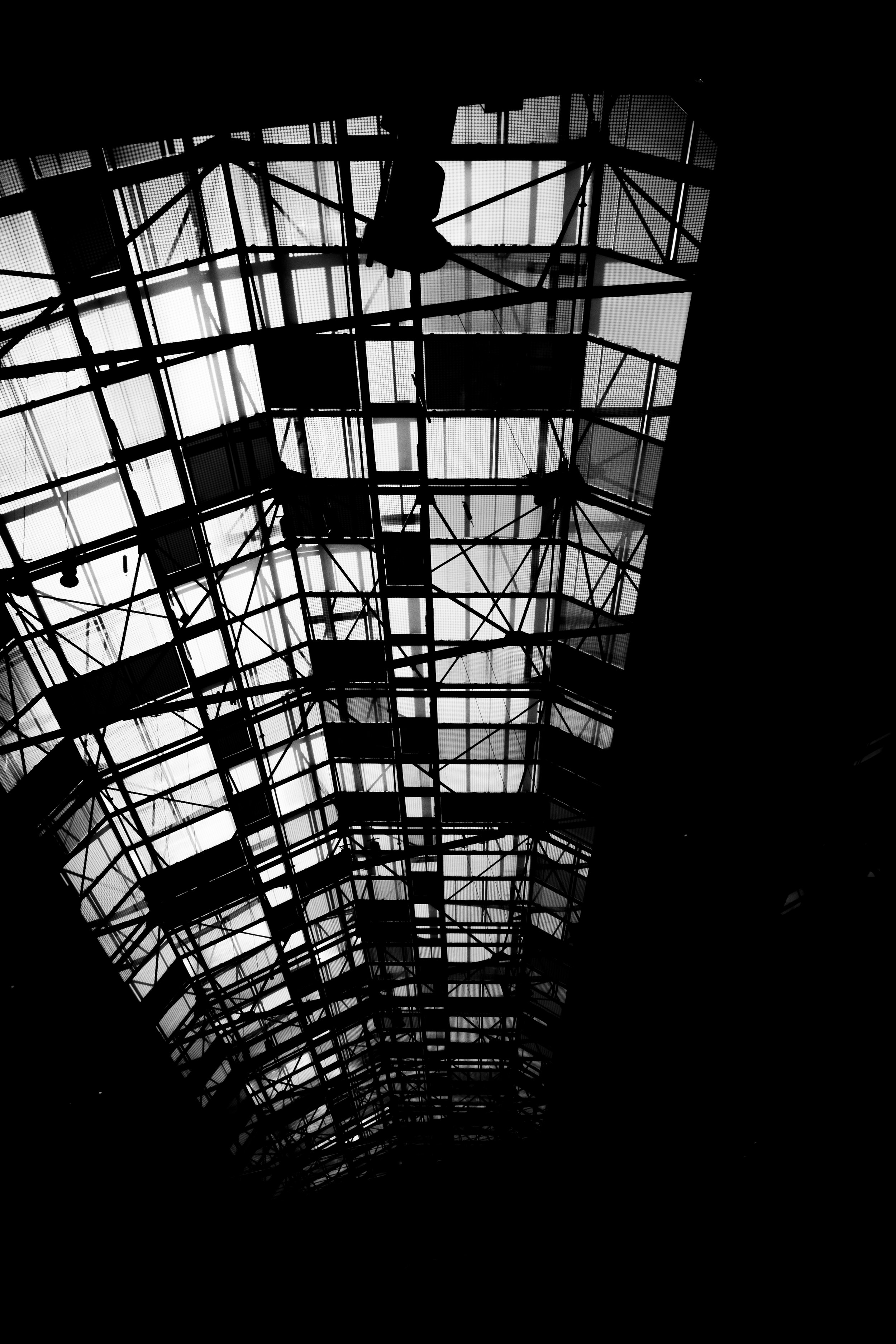 Interior view of a glass and metal ceiling structure in black and white.