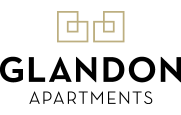 An illustration of two white and black robot-like creatures with square heads and rectangular bodies, smiling and facing forward, against a black background.