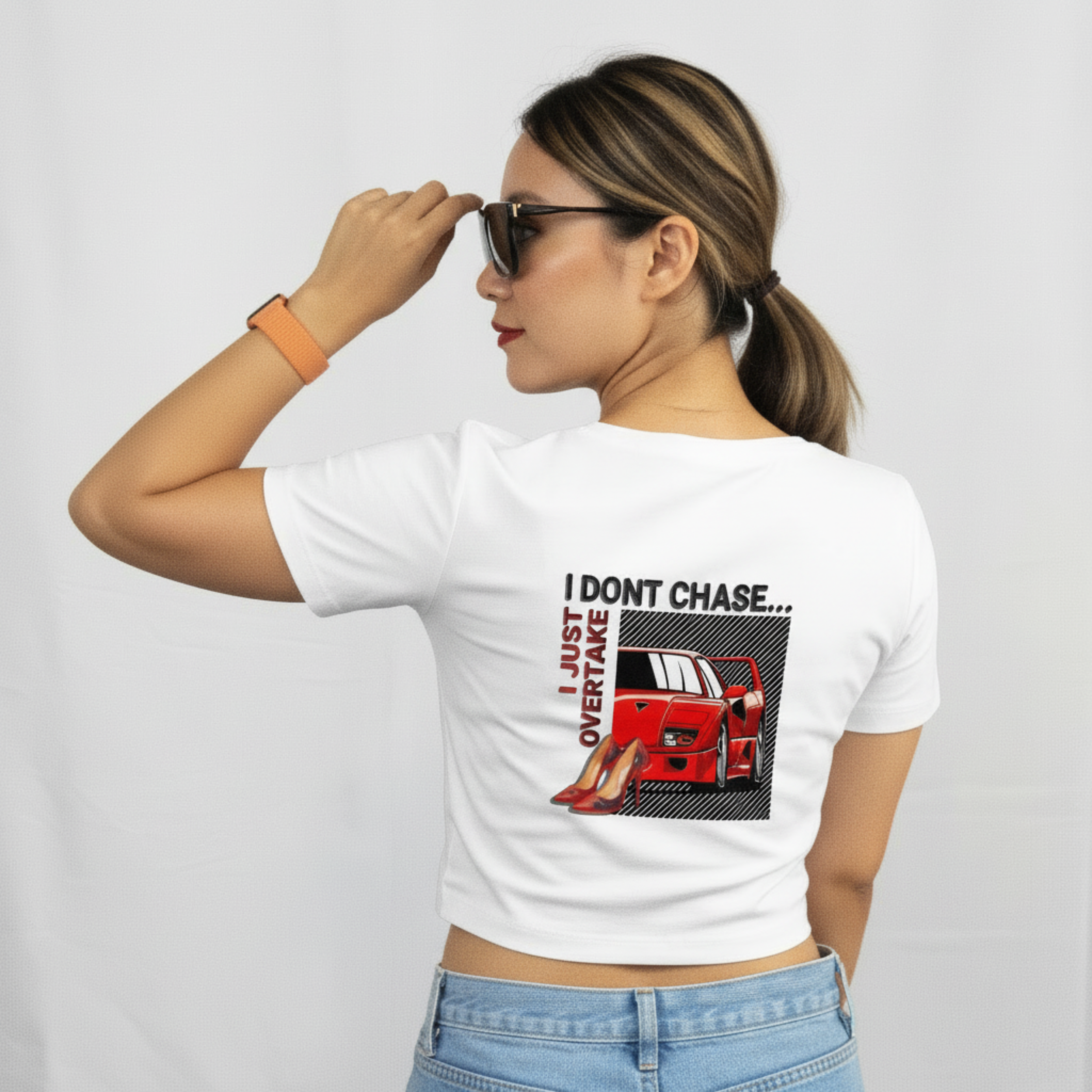 White graphic t-shirt by DRS Apparel featuring a red Ferrari F40 and red high heels with the text 'I Don't Chase... I Just Overtake' in a modern streetwear style.