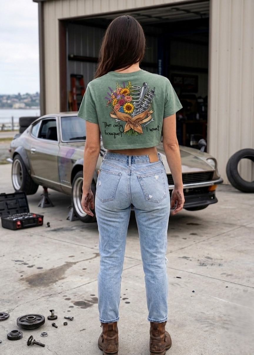 Back view of a sage green graphic crop top on a women, featuring a coil-over and flower bouquet design with the text 'The only bouquet I want.' This lifestyle streetwear piece sits at the intersection of California coastal style and Miami's luxury ca
